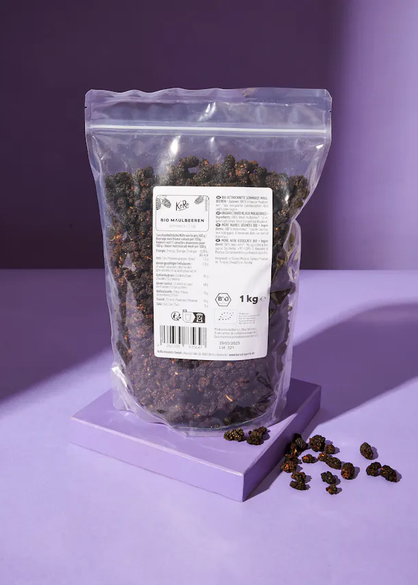 a bag of dried mulberries sits on a purple table