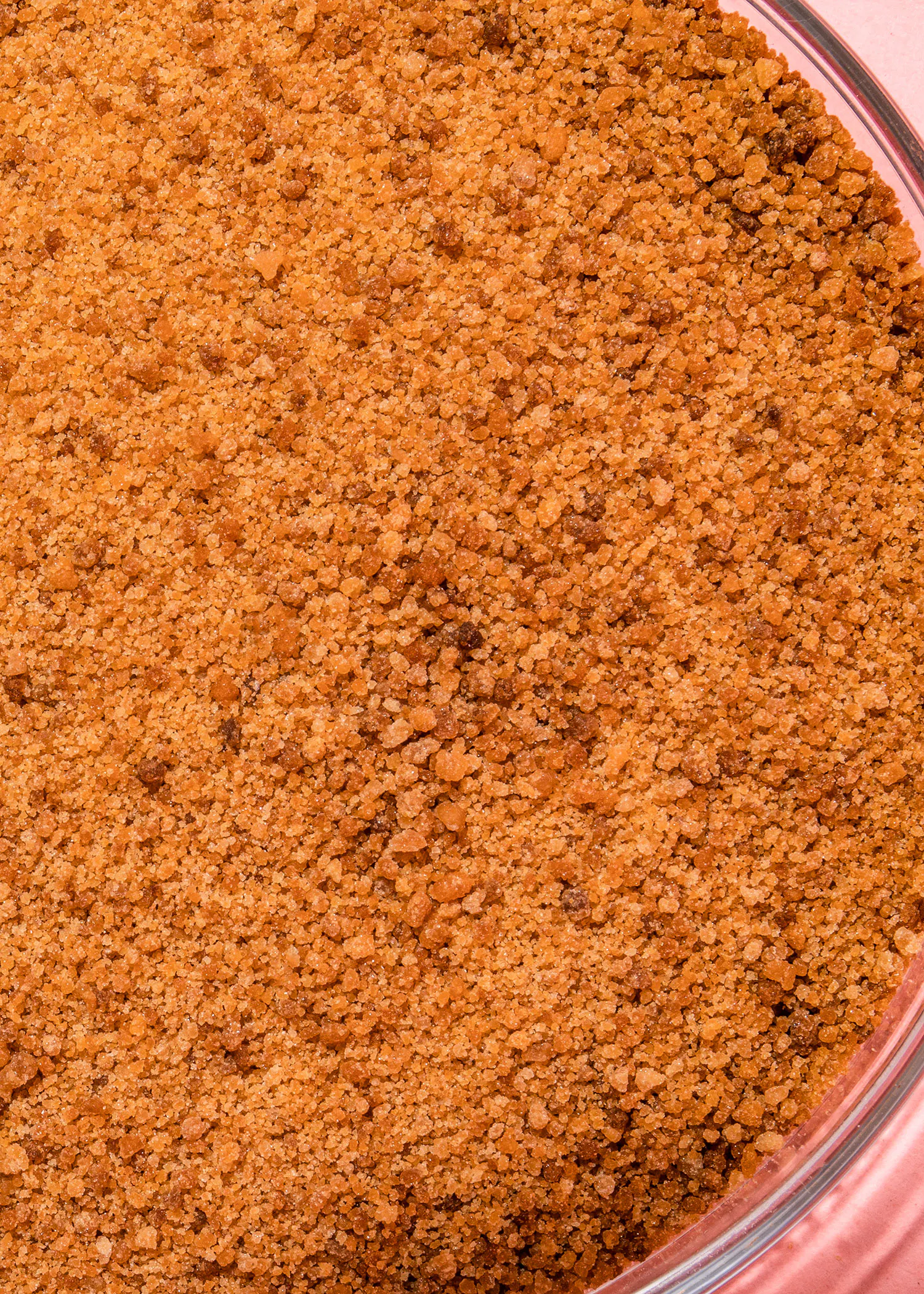 a close up of a brown colored powder in a glass bowl