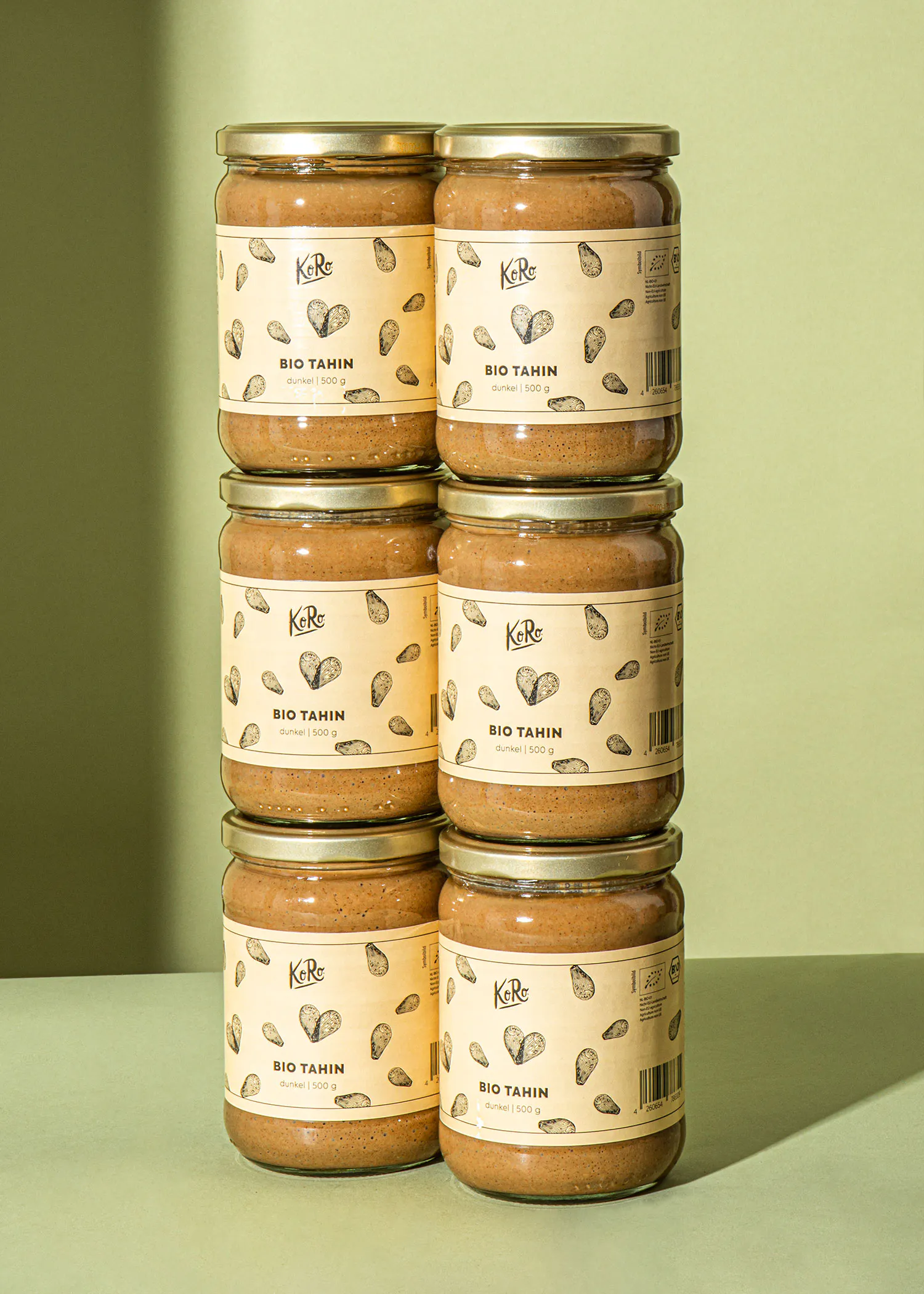several jars of bio tahin are stacked on top of each other