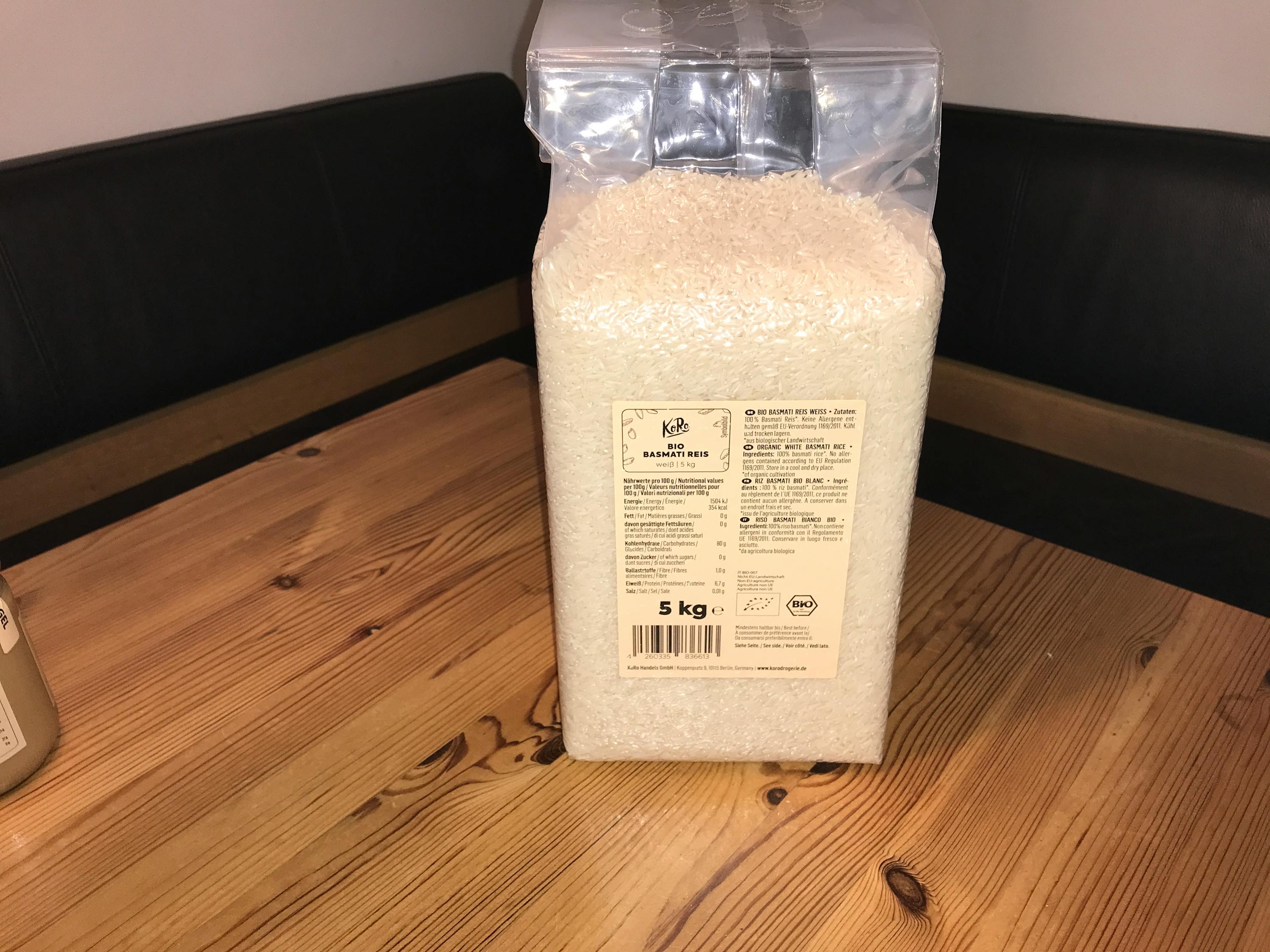 a bag of basmati rice is sitting on a wooden table