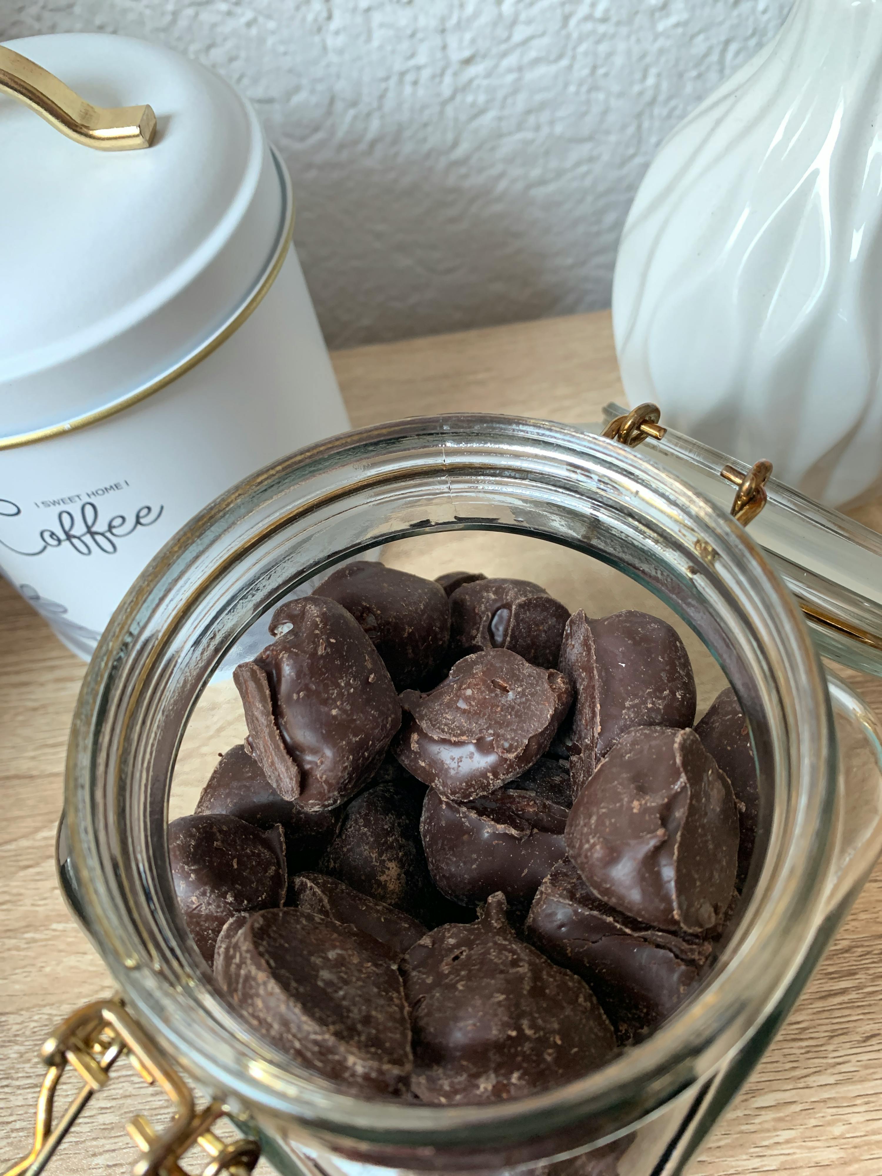 a jar of chocolate chips next to a coffee can
