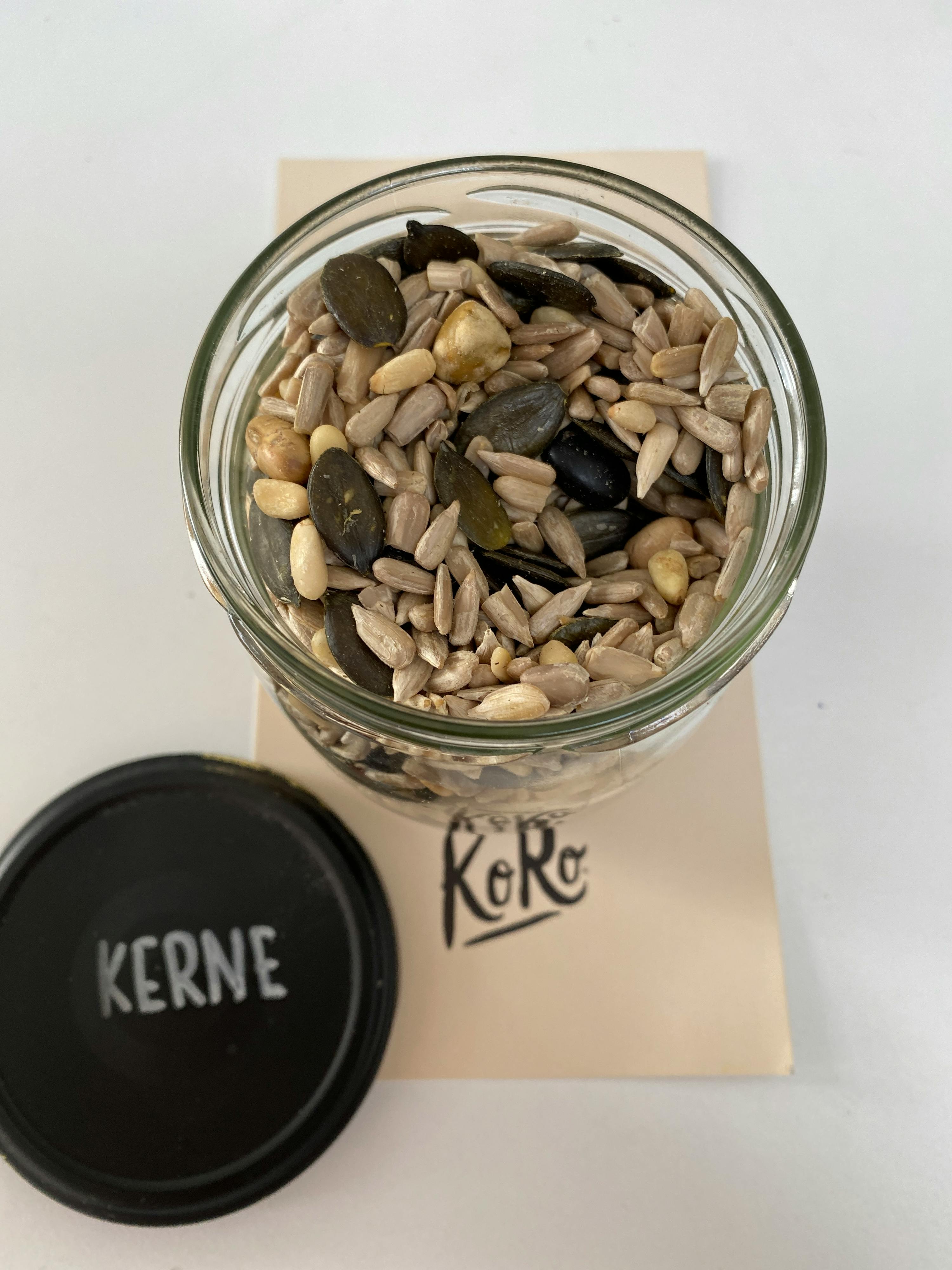 a jar of kernels sits next to a piece of paper