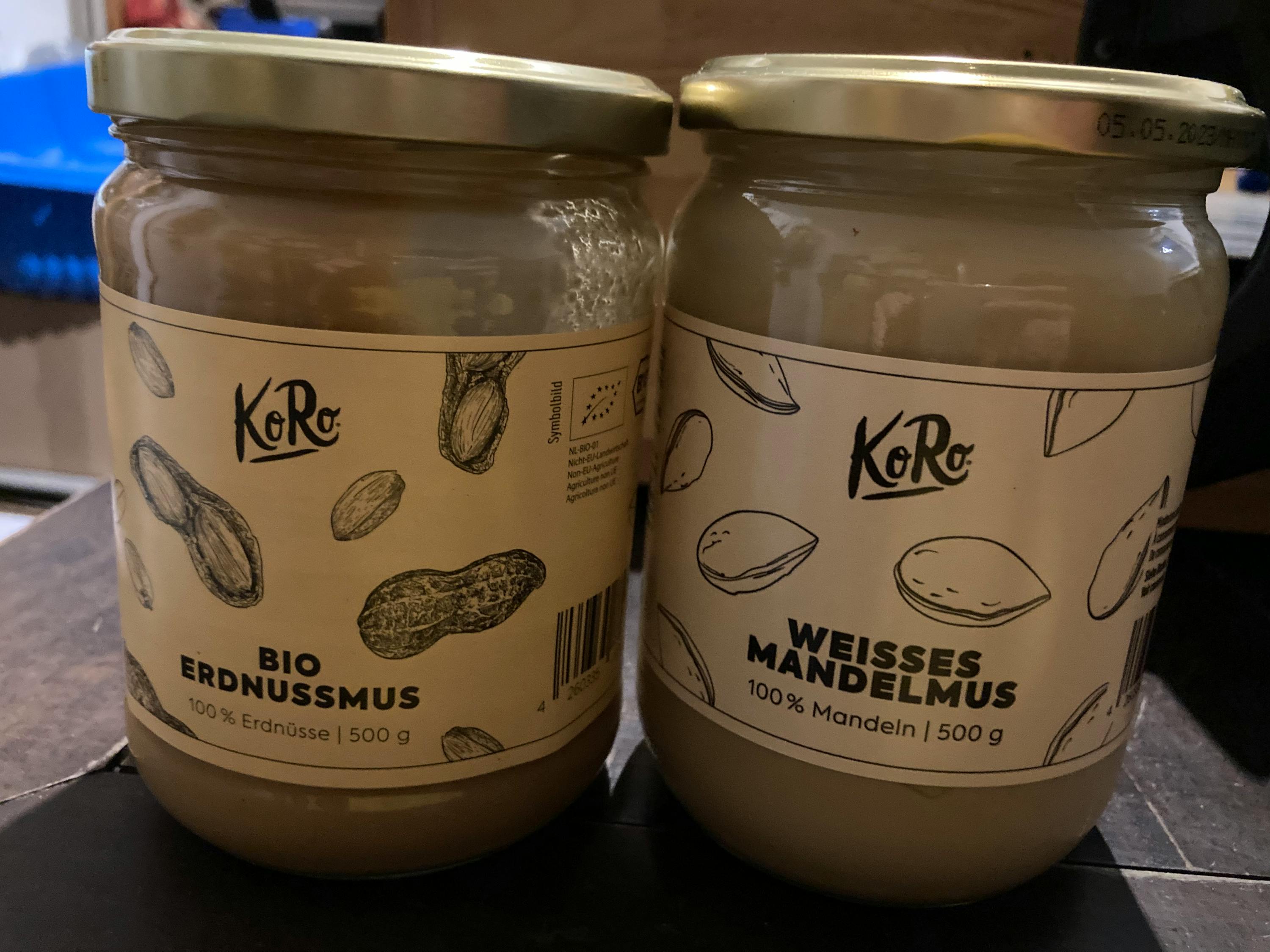 two jars of peanut butter with the word koro on them