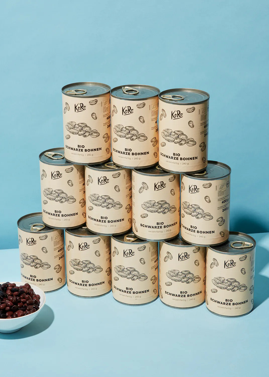 a stack of cans of bio schwarze bohnen on a blue background