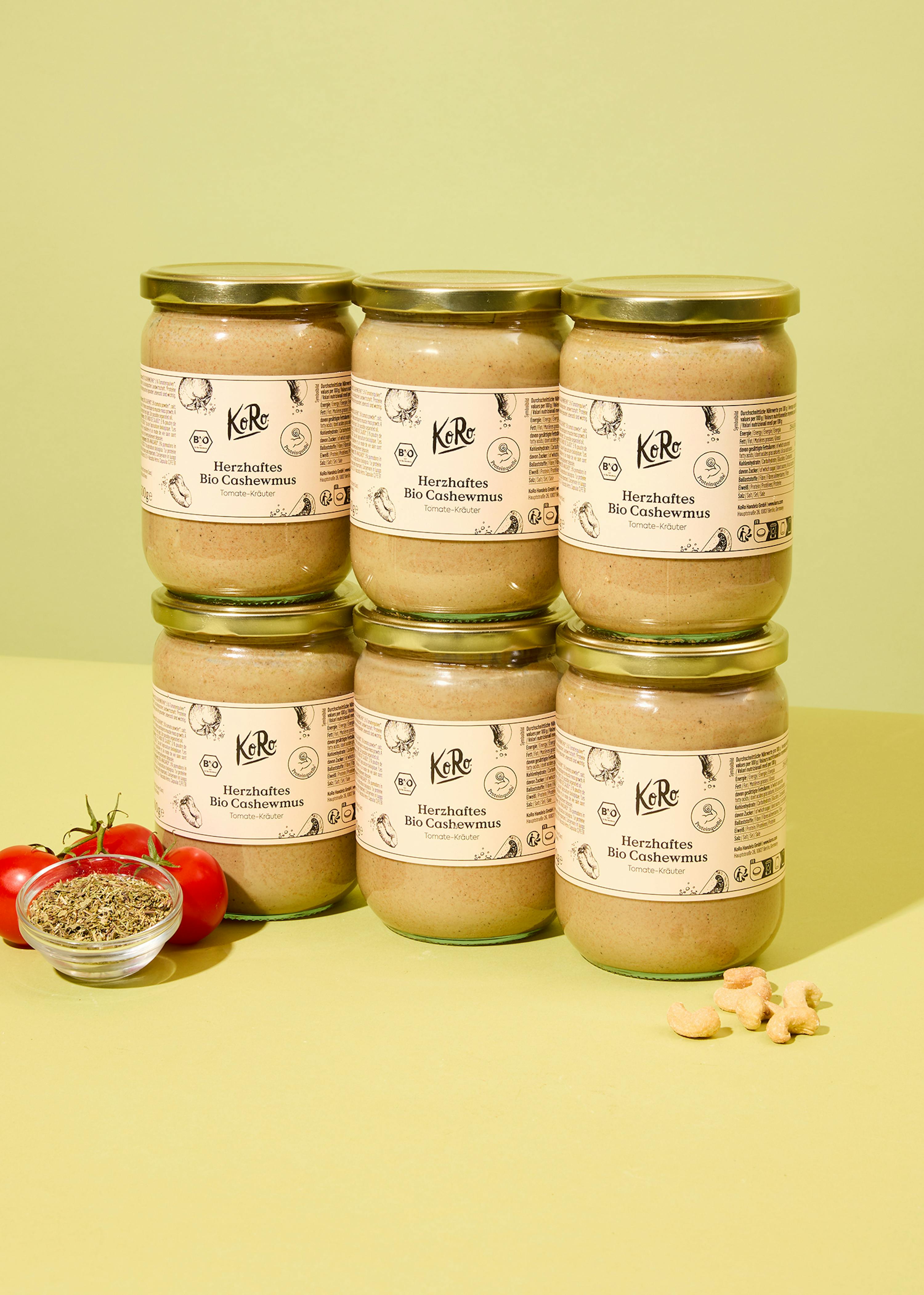 sechs Gläser herzhafter bio-cashewmus auf einem Tisch