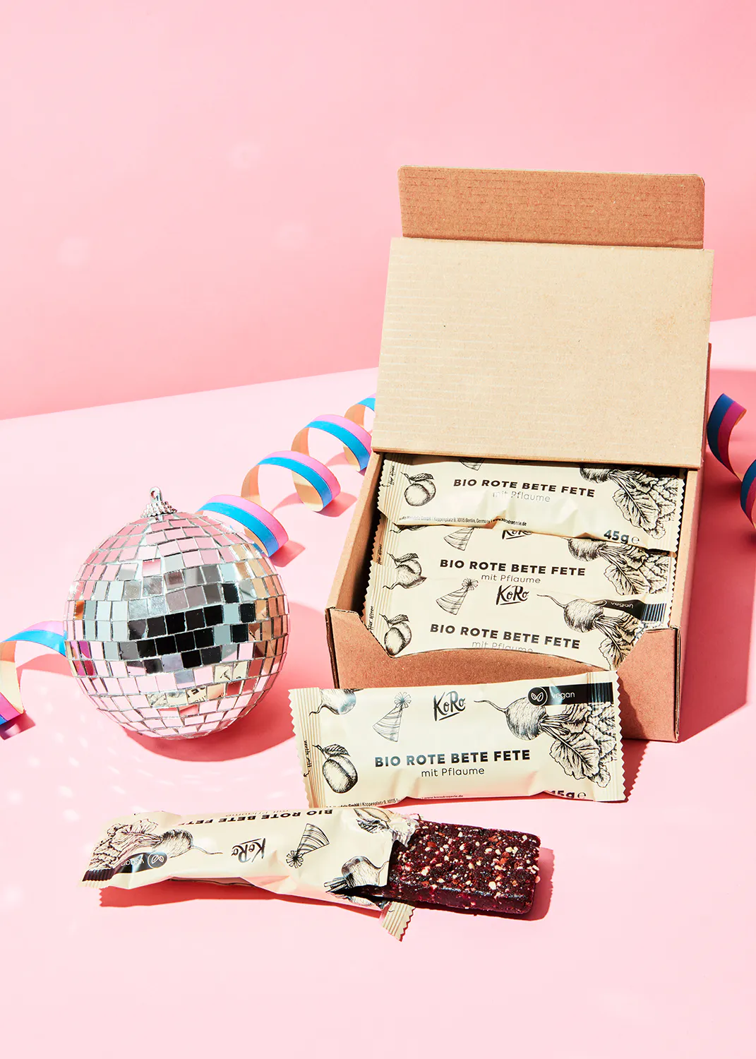 a box of bio rote bete fete bars sits next to a disco ball