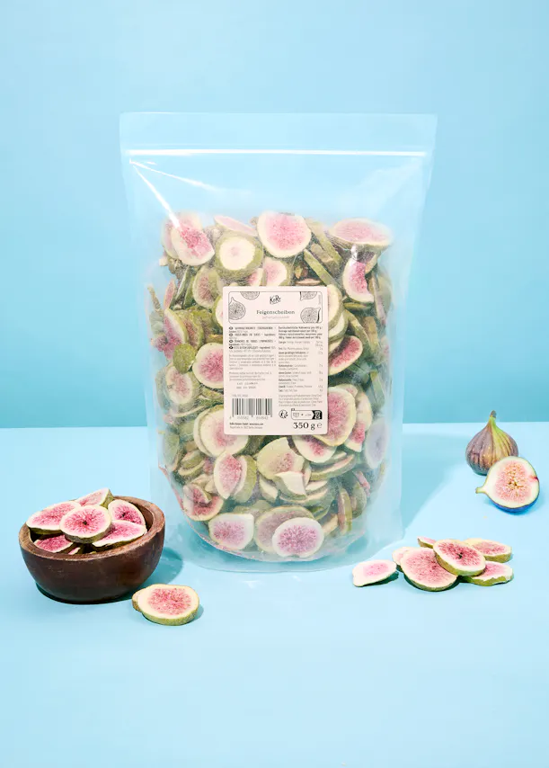 a bag of sliced figs sits on a blue surface