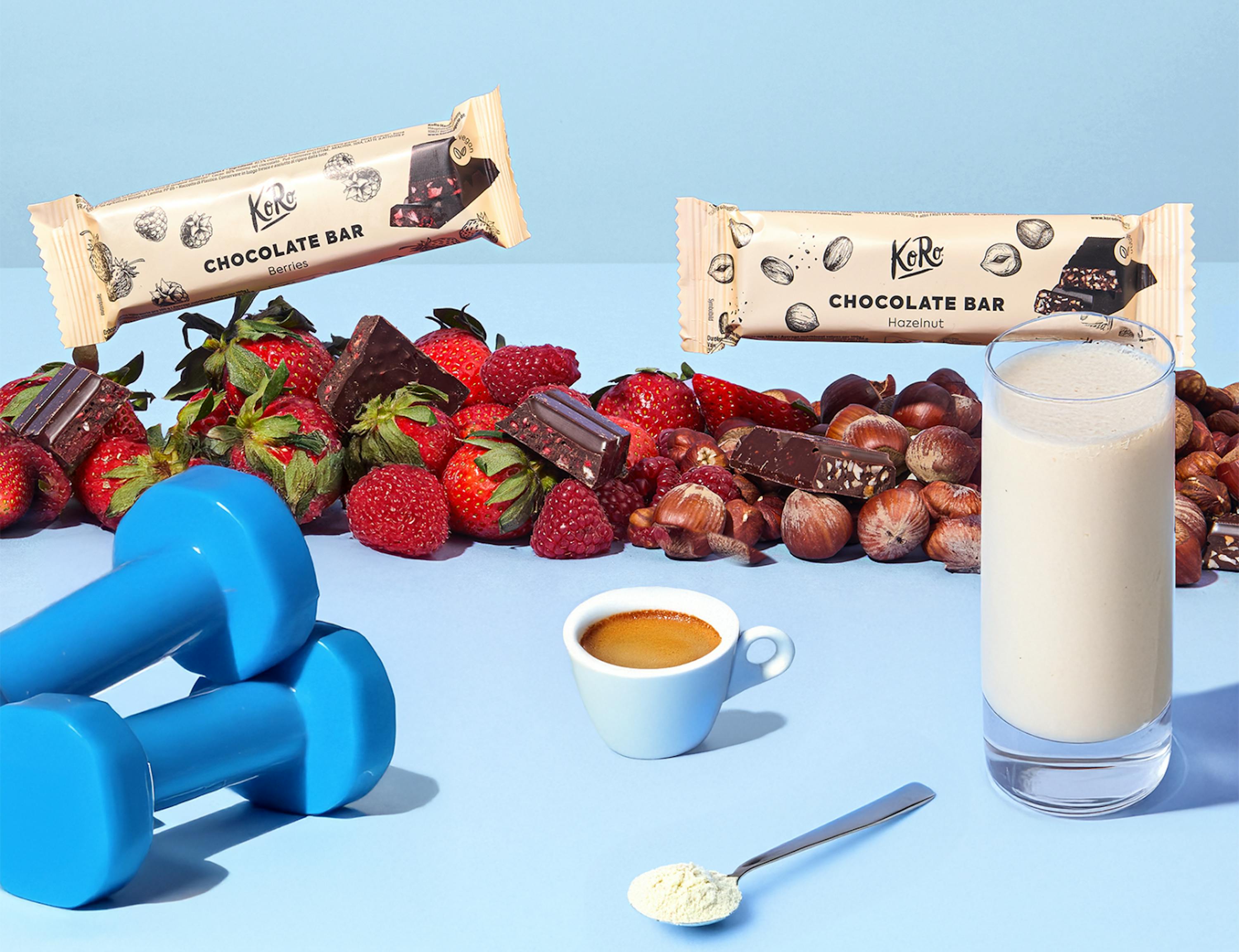 a chocolate bar with strawberries nuts and a glass of milk