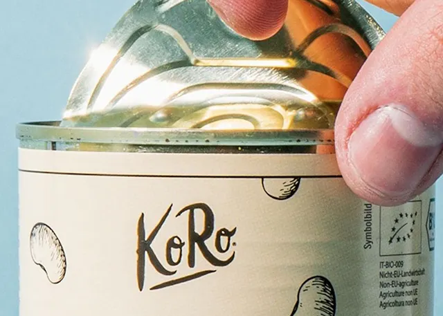 a person is opening a can of koro food