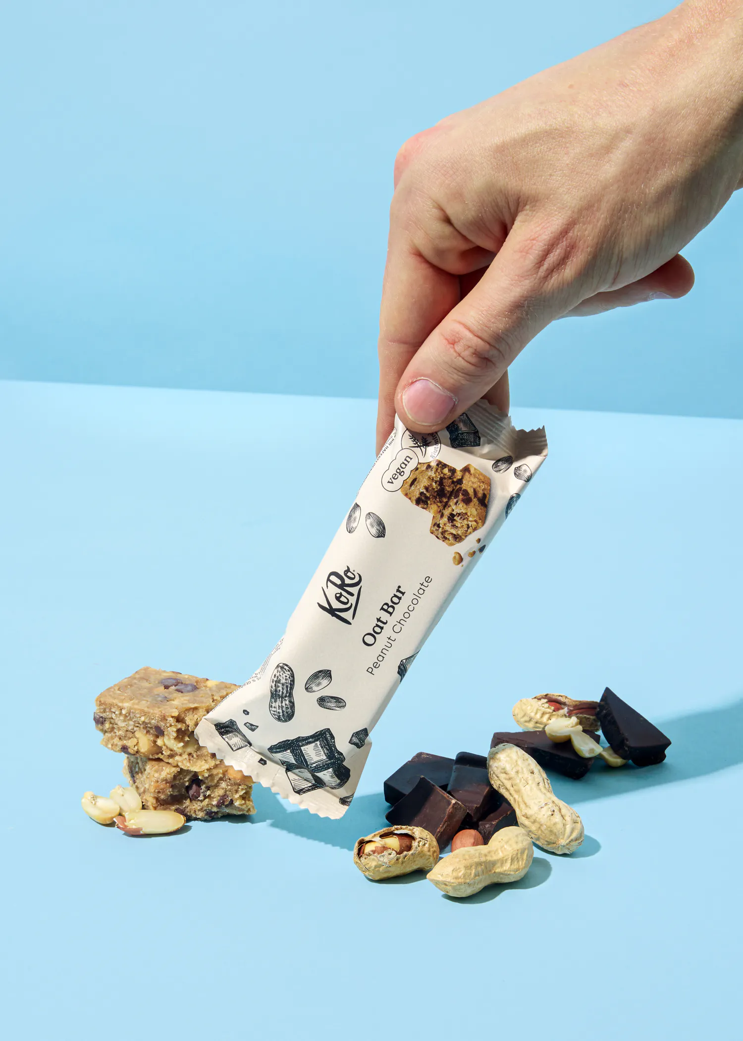 a person is holding a oat bar in their hand