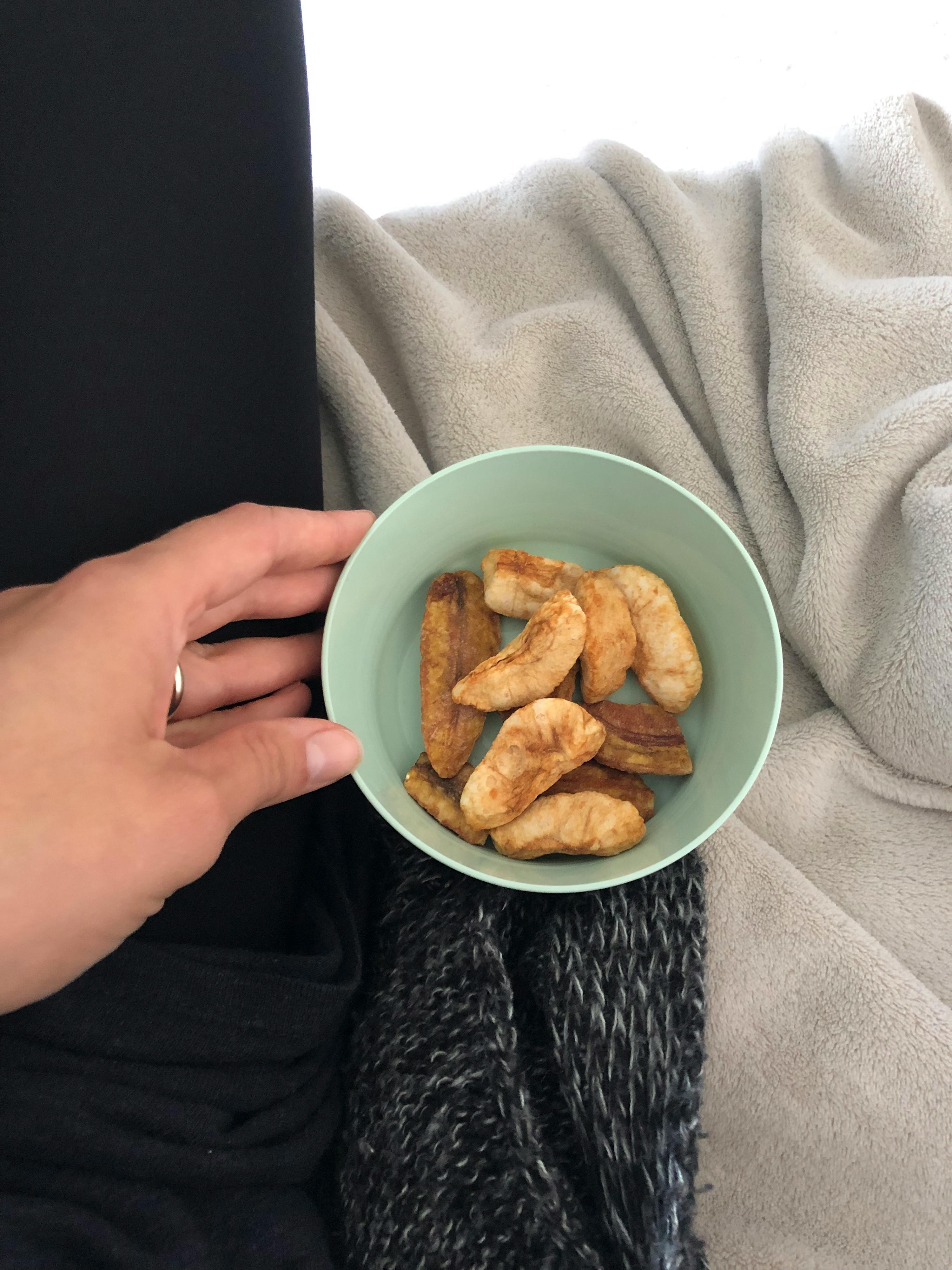 a person holding a bowl of food in their hand