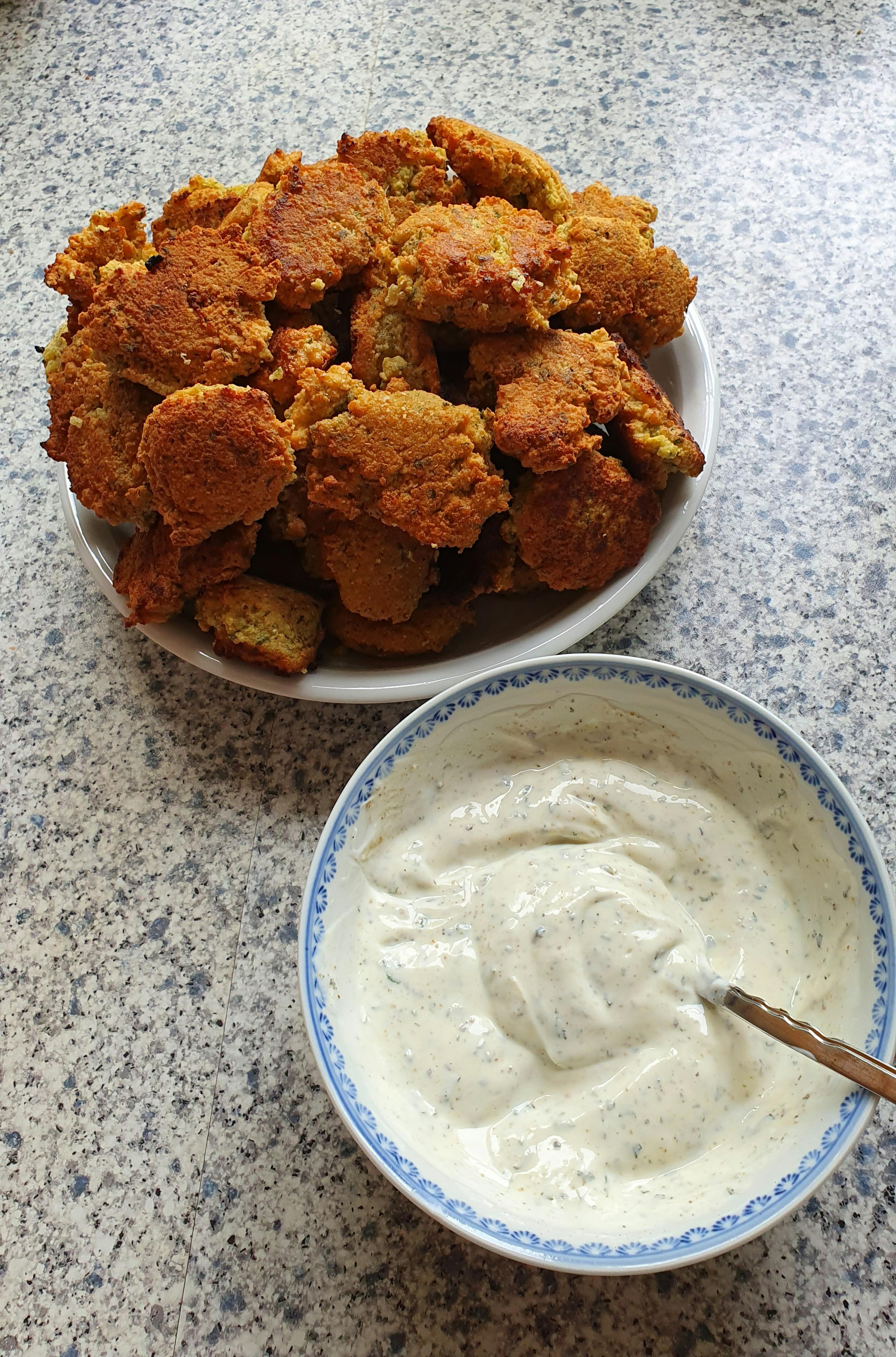 a bowl of yogurt next to a plate of food
