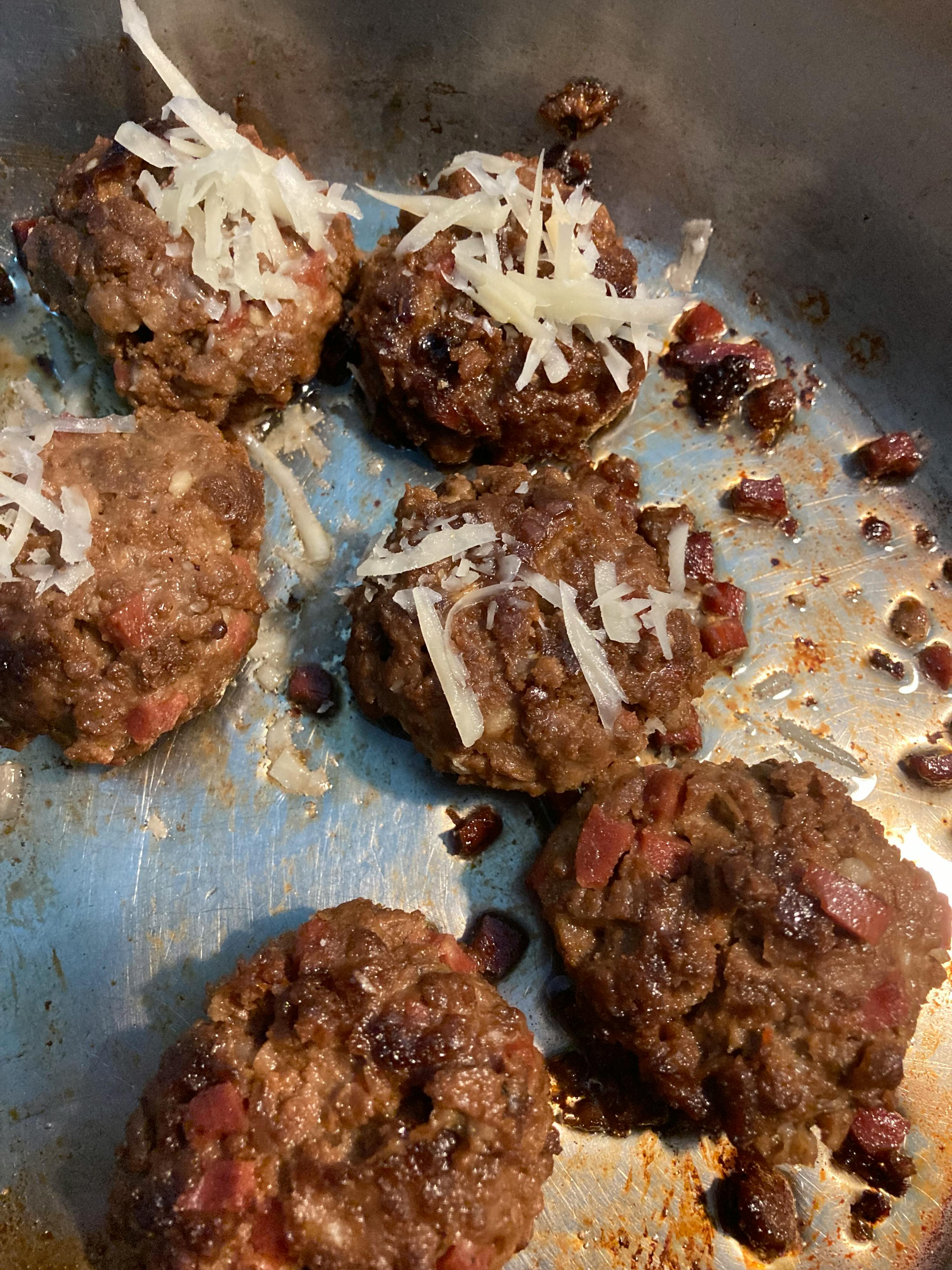 meatballs with cheese and bacon in a pan