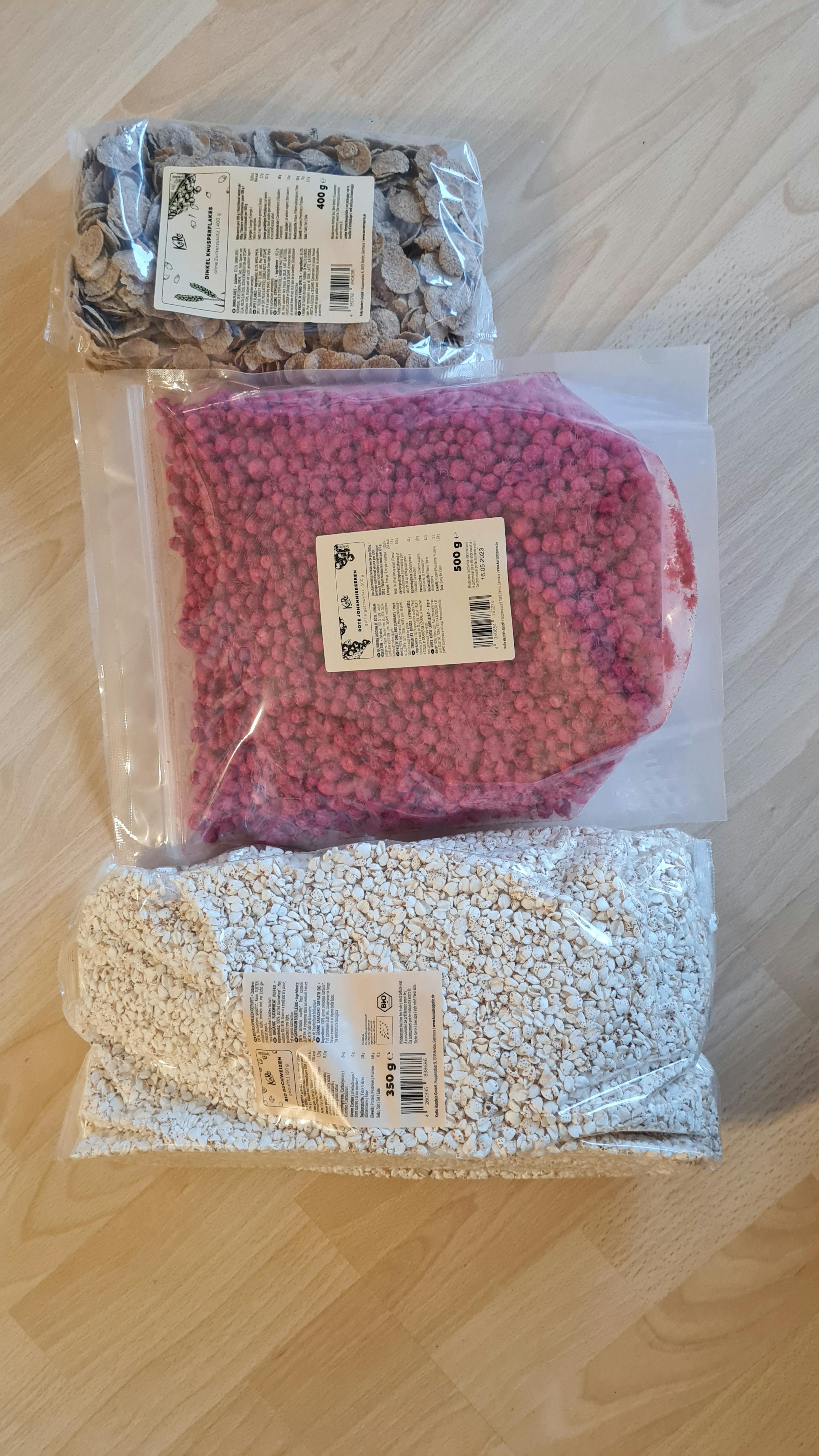 a bag of pink beans sits next to a bag of white rocks