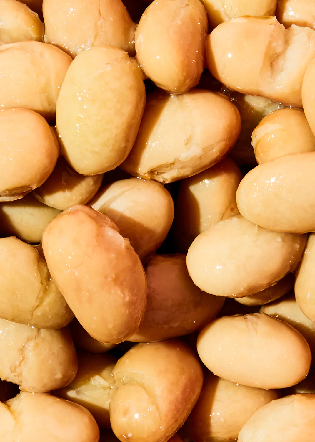 a pile of beans with water drops on them