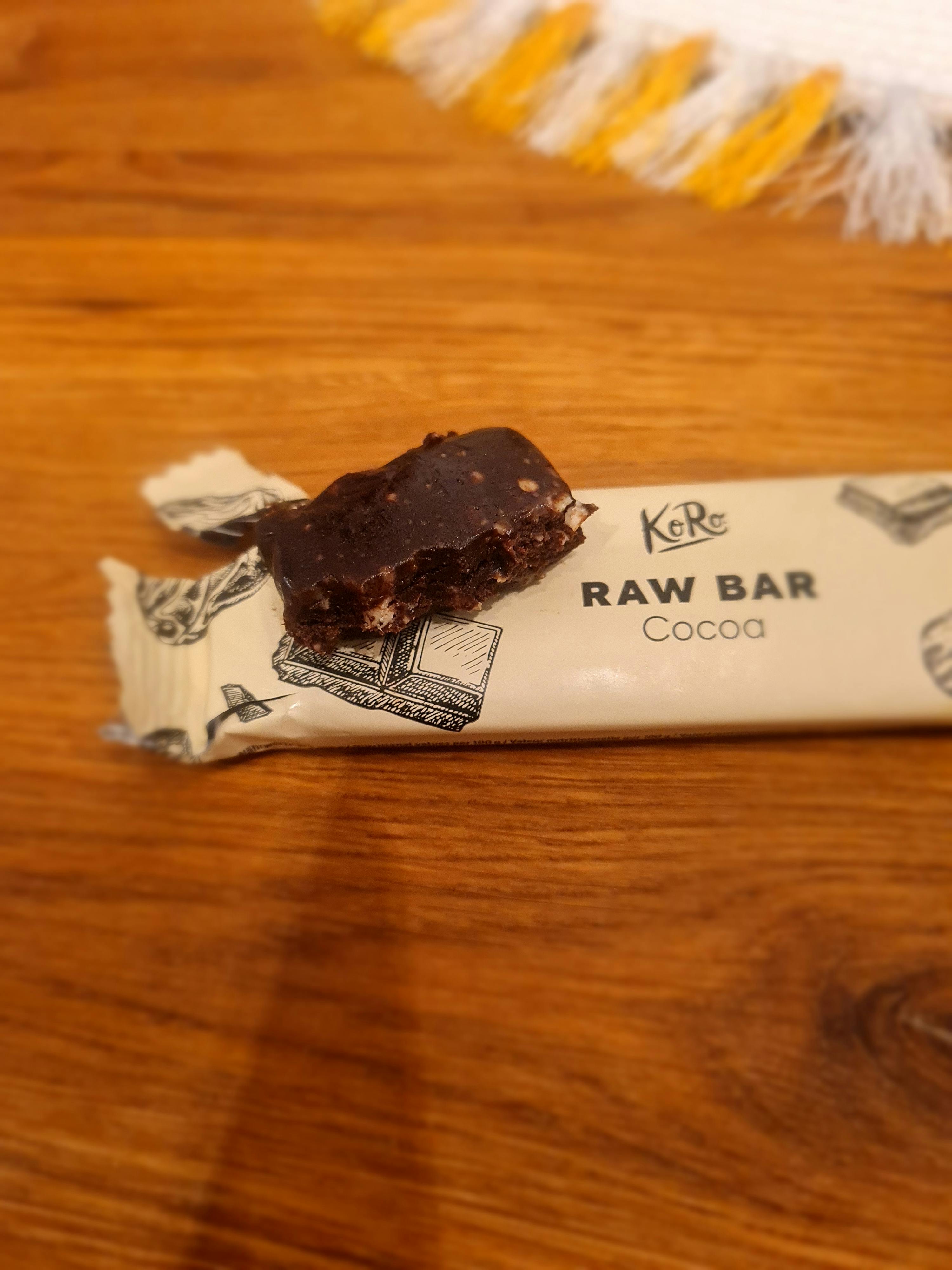 a raw bar with a bite taken out of it sits on a wooden table