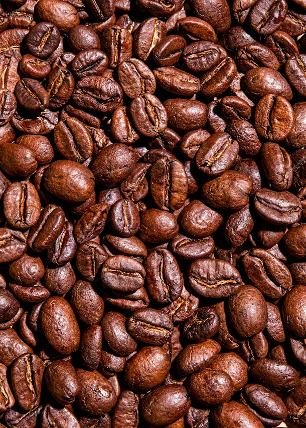 a pile of roasted coffee beans with a yellow center