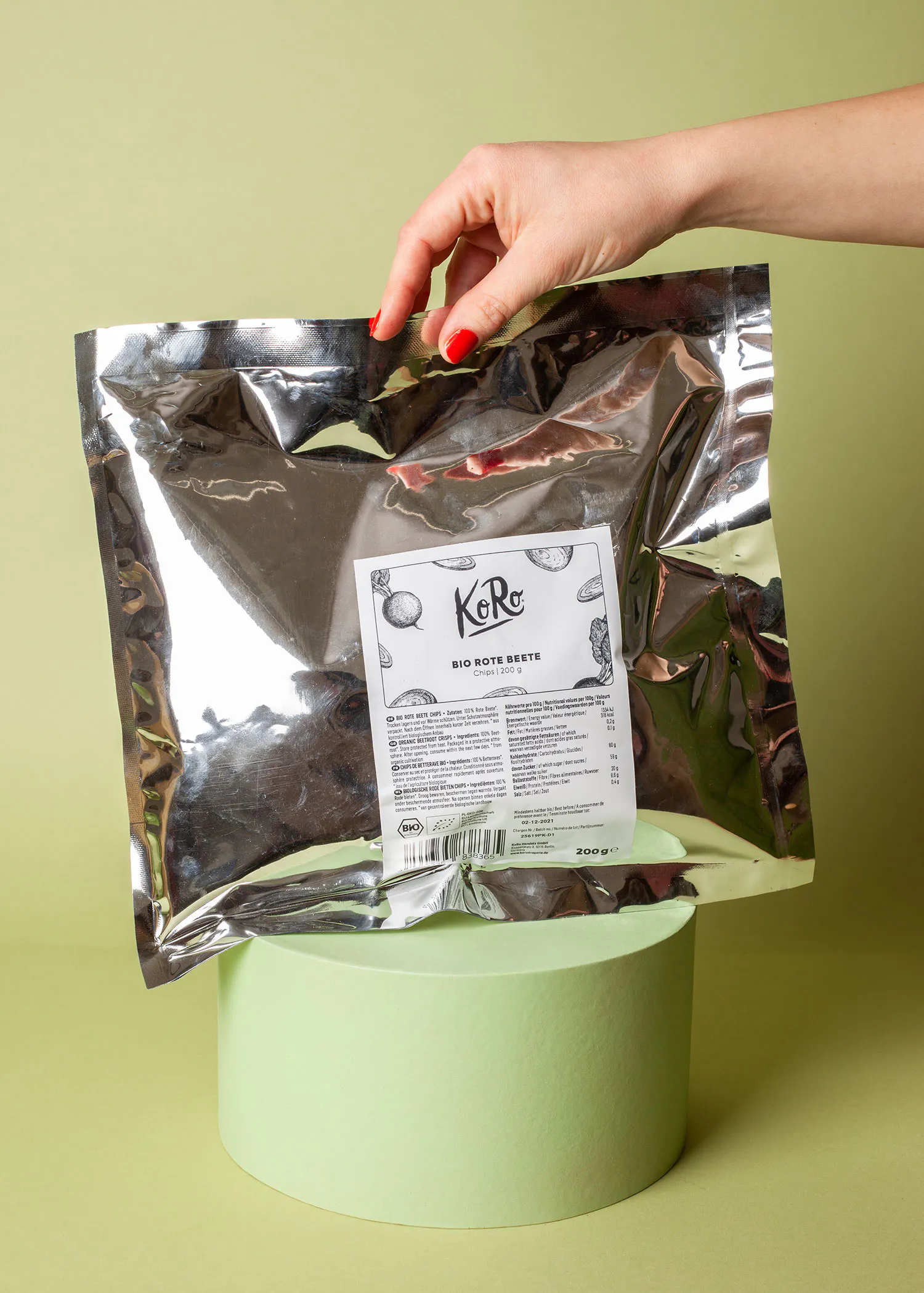 a person is holding a bag of bio rote beets