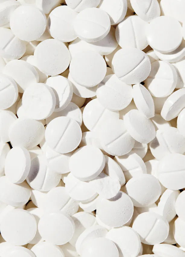 a pile of white pills with the number 1 on them