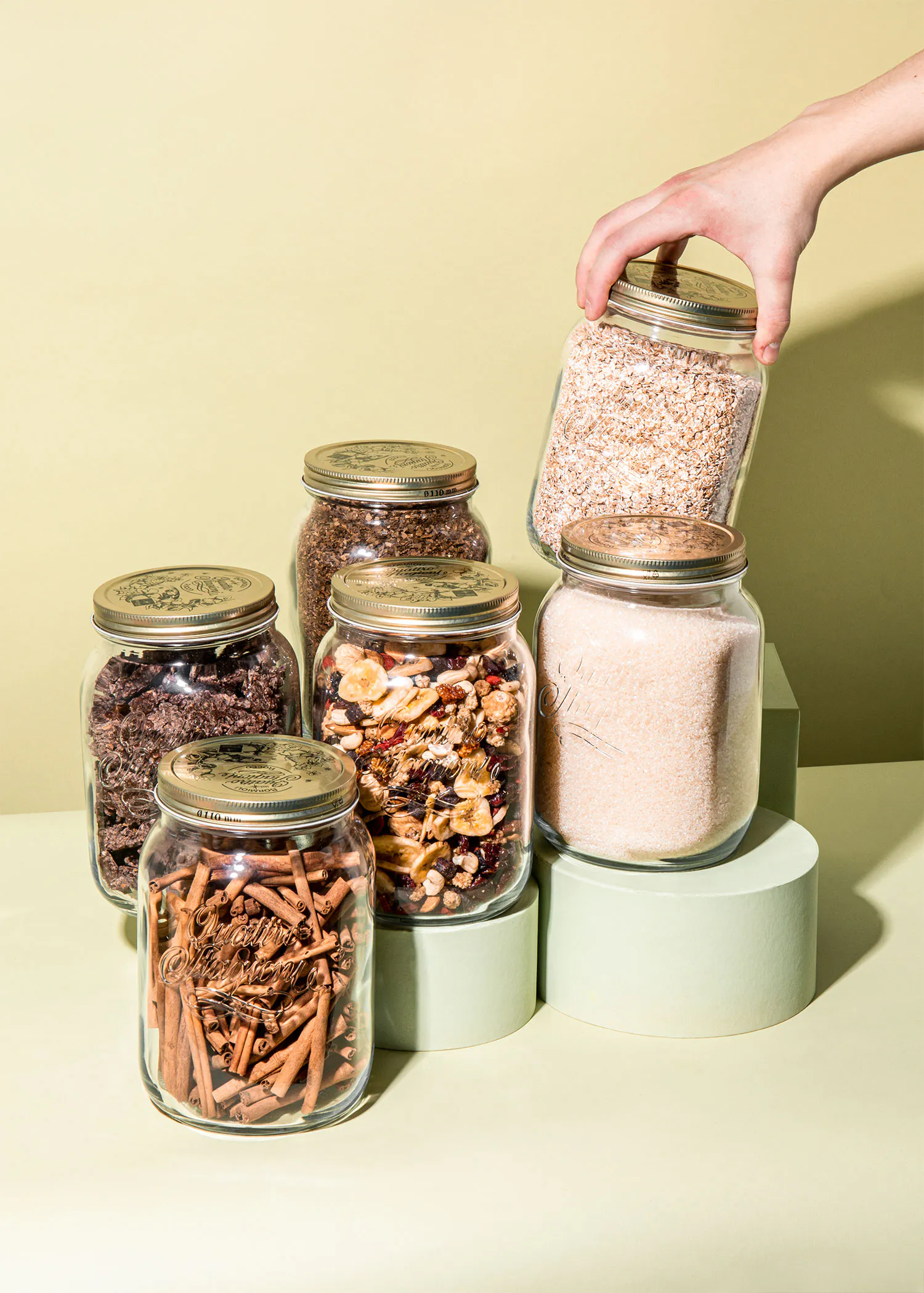 a person is reaching into a jar of oatmeal
