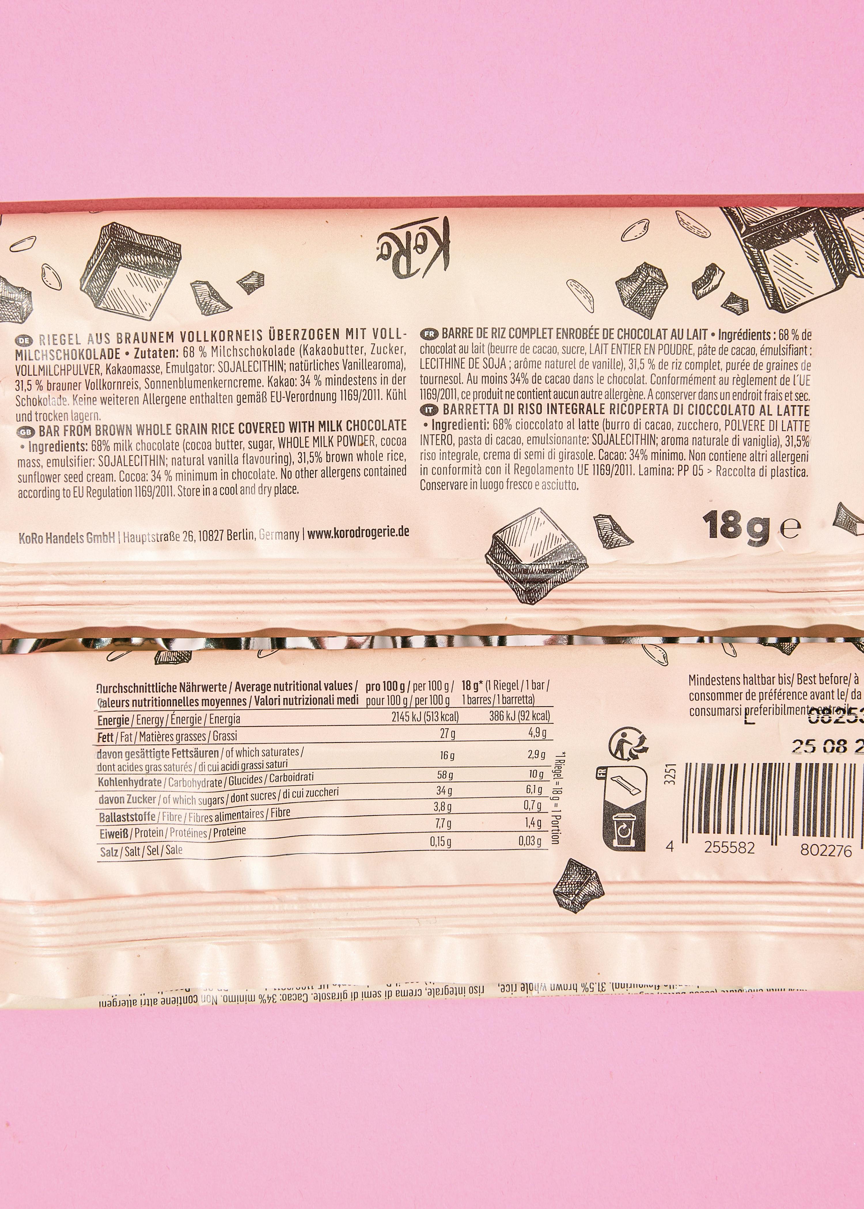 a koro brown whole grain rice bar covered with milk chocolate, featuring ingredient lists, nutritional information, and a barcode on its packaging.