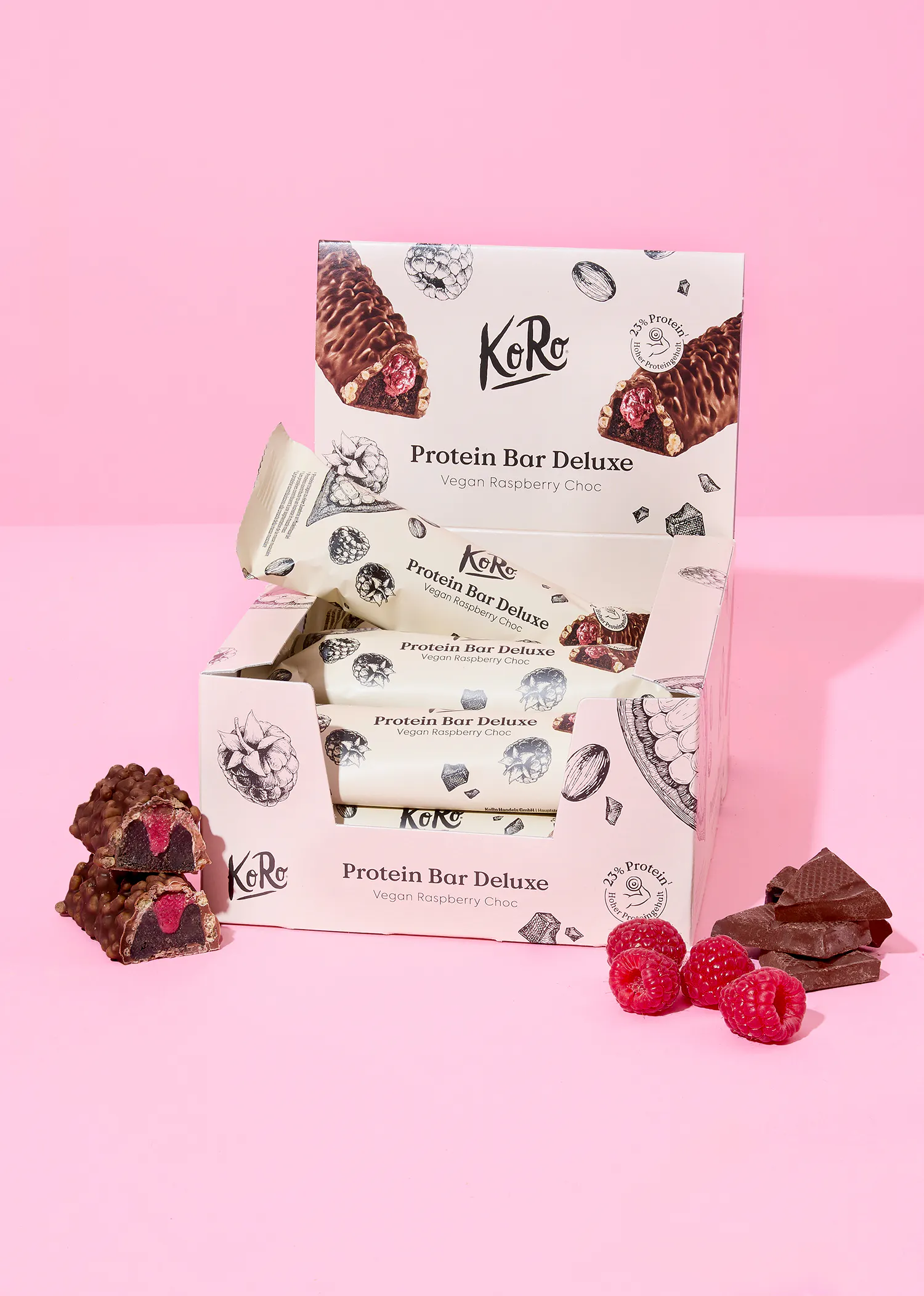 a box of karo protein bar deluxe sitting on a pink surface