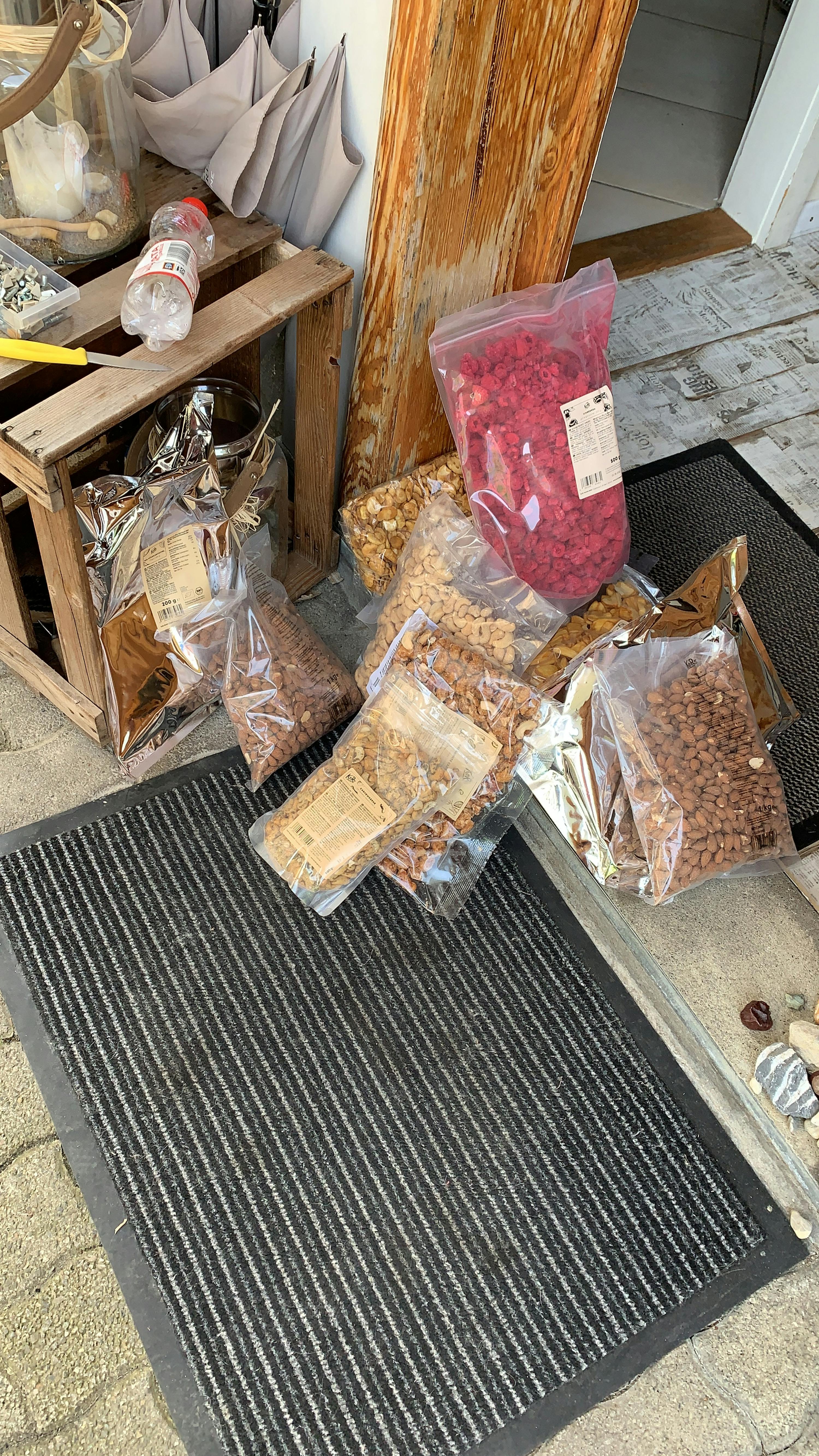 a bag of raspberries sits next to a bag of almonds