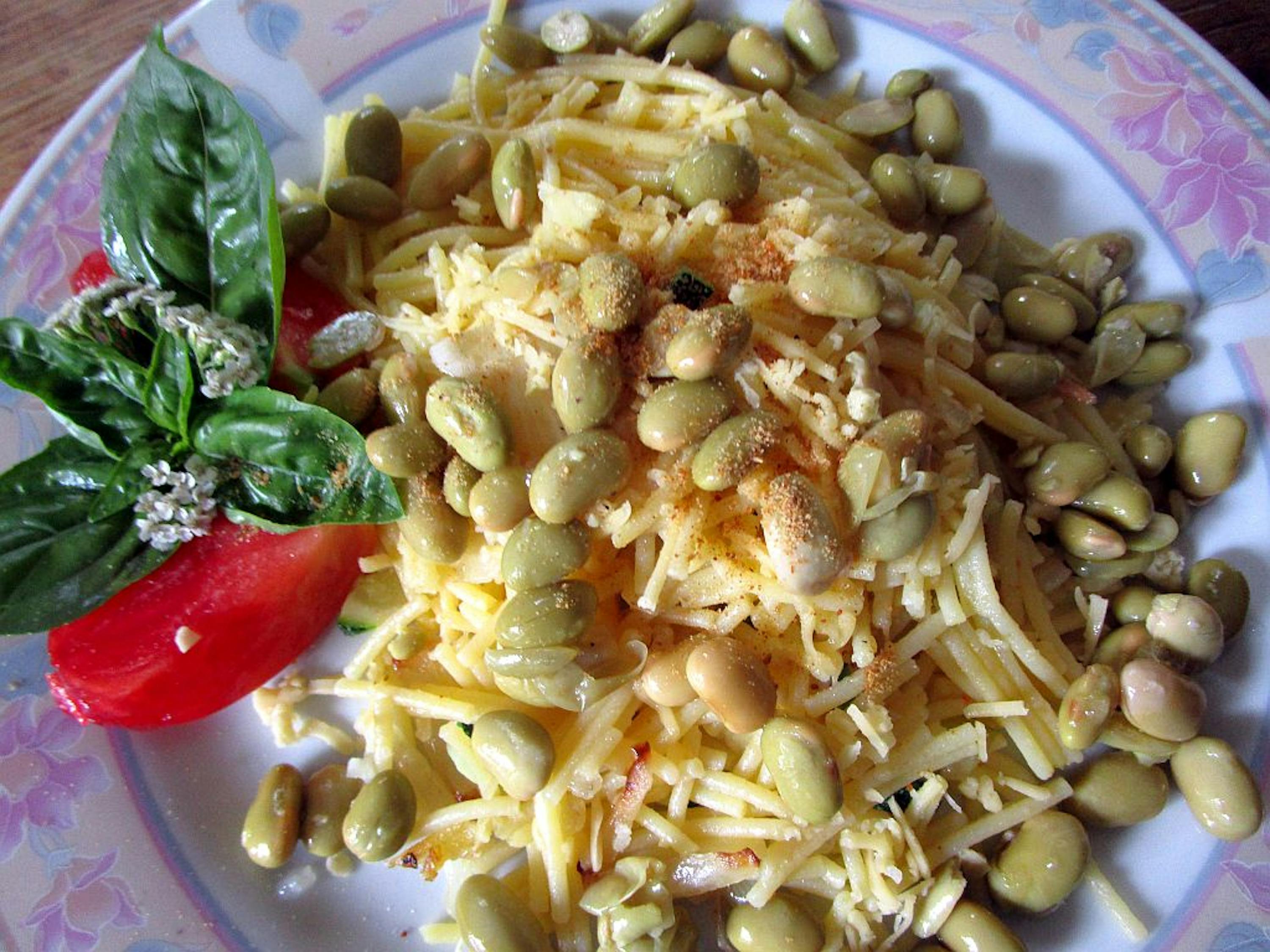 a plate of food with a tomato and basil on it