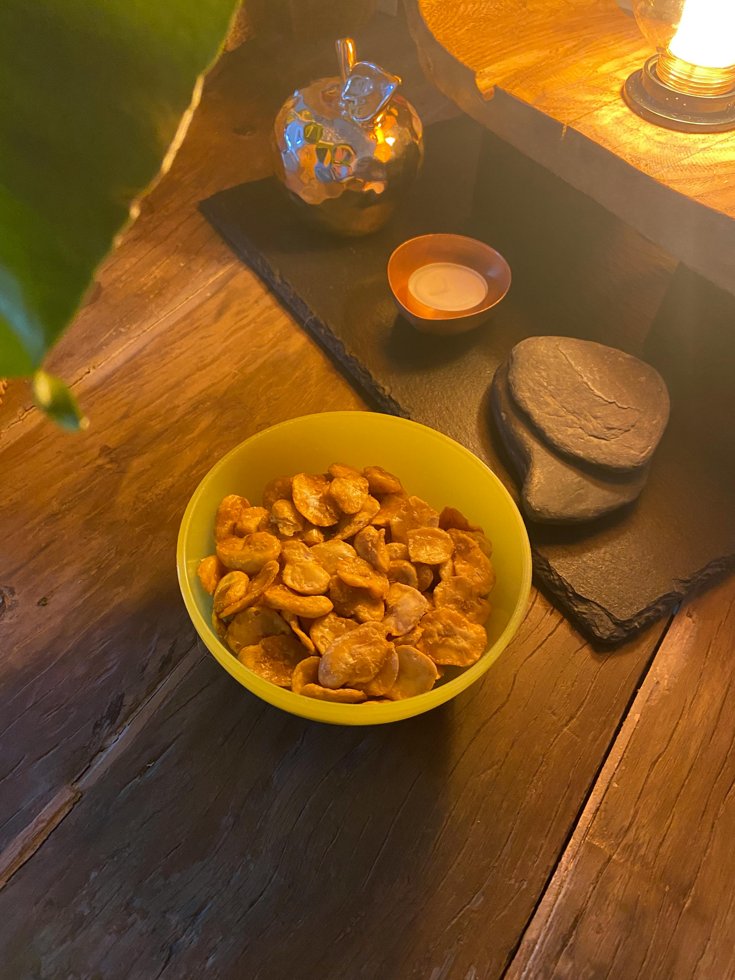 a yellow bowl of cereal sits on a wooden table