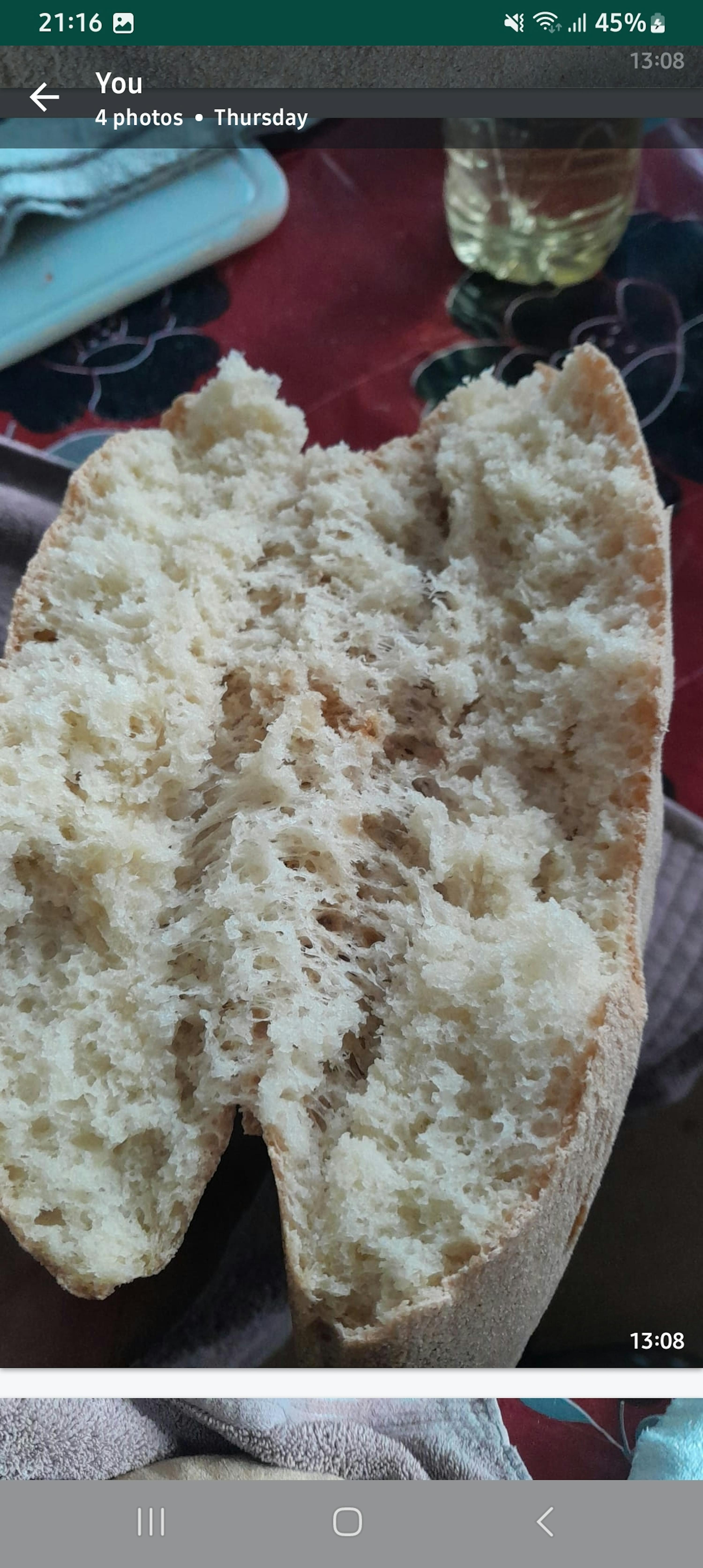 a phone screen shows a picture of a loaf of bread and the time of 13:58