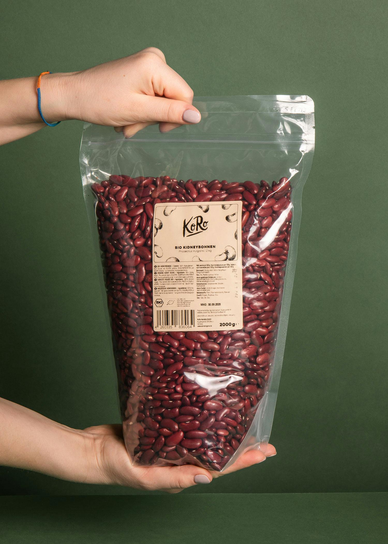 a person holding a bag of red kidney beans