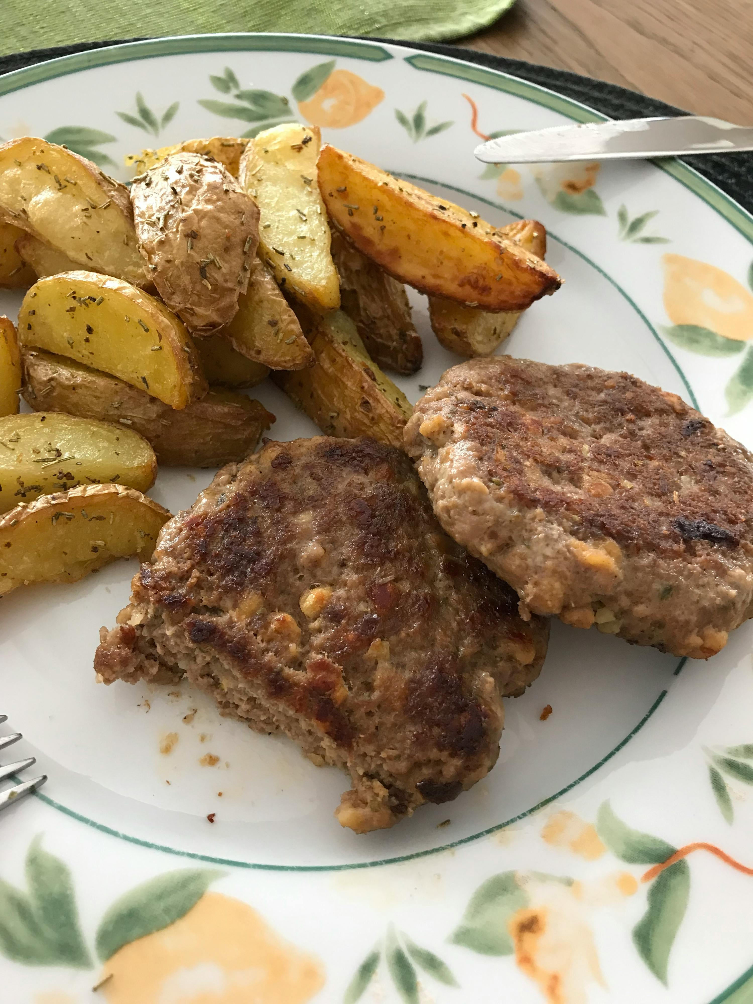 a plate of food with meat and potatoes on a table