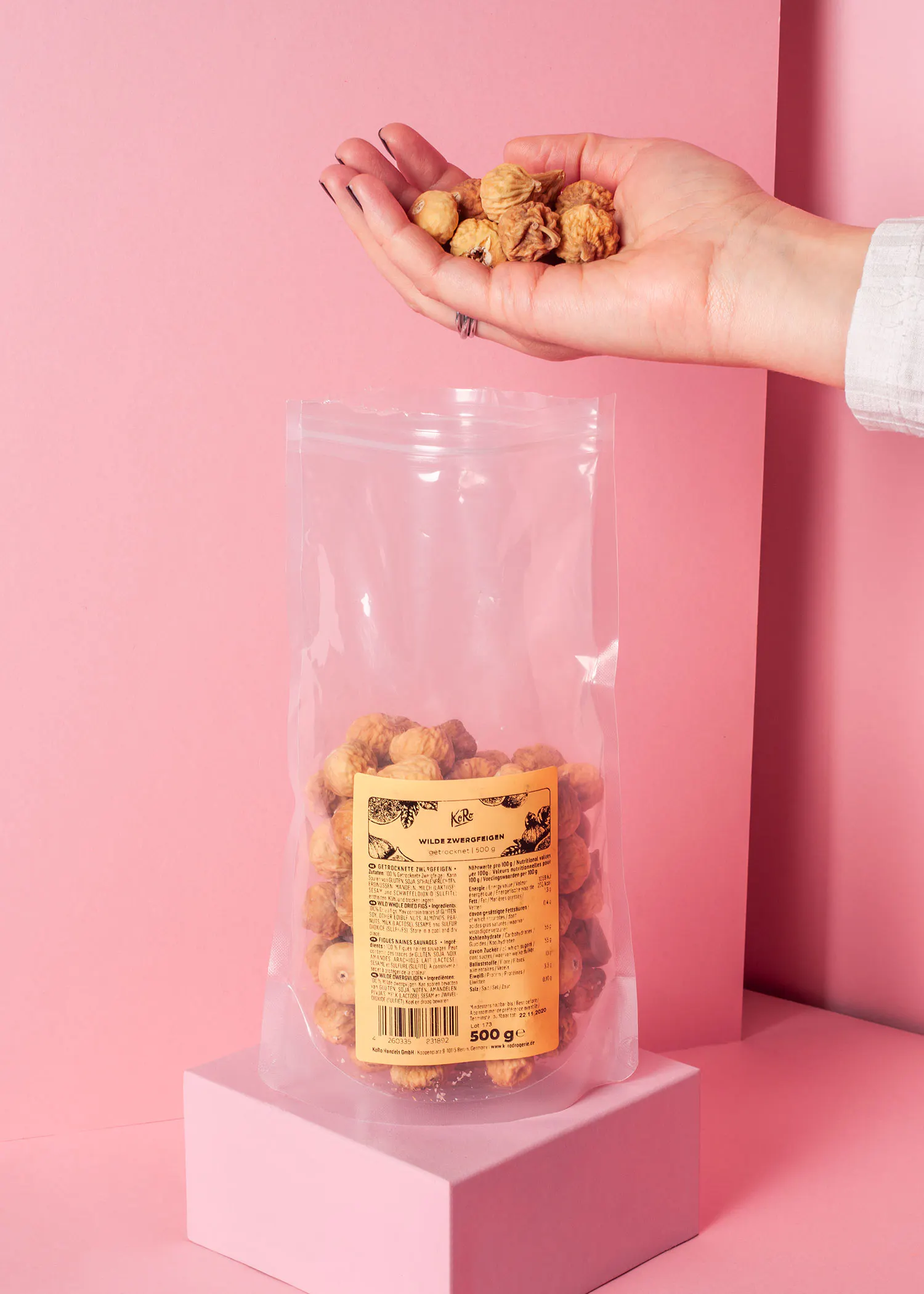 a person is holding a bag of nuts with a label that says 500g