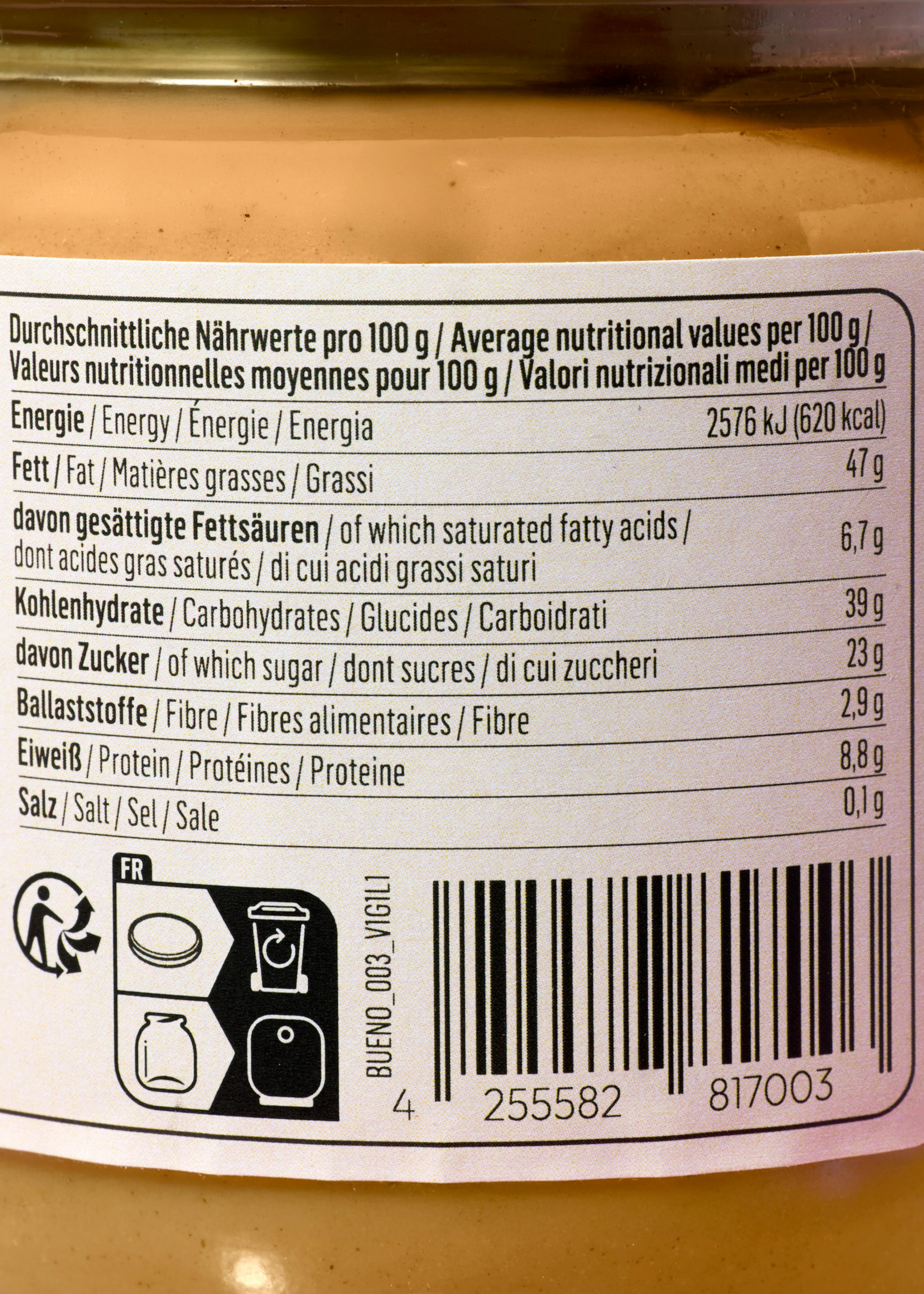 a close-up of a nutritional label showing average nutritional values per 100g for energy, fat, carbohydrates, fiber, protein, and salt, along with recycling symbols and a barcode.