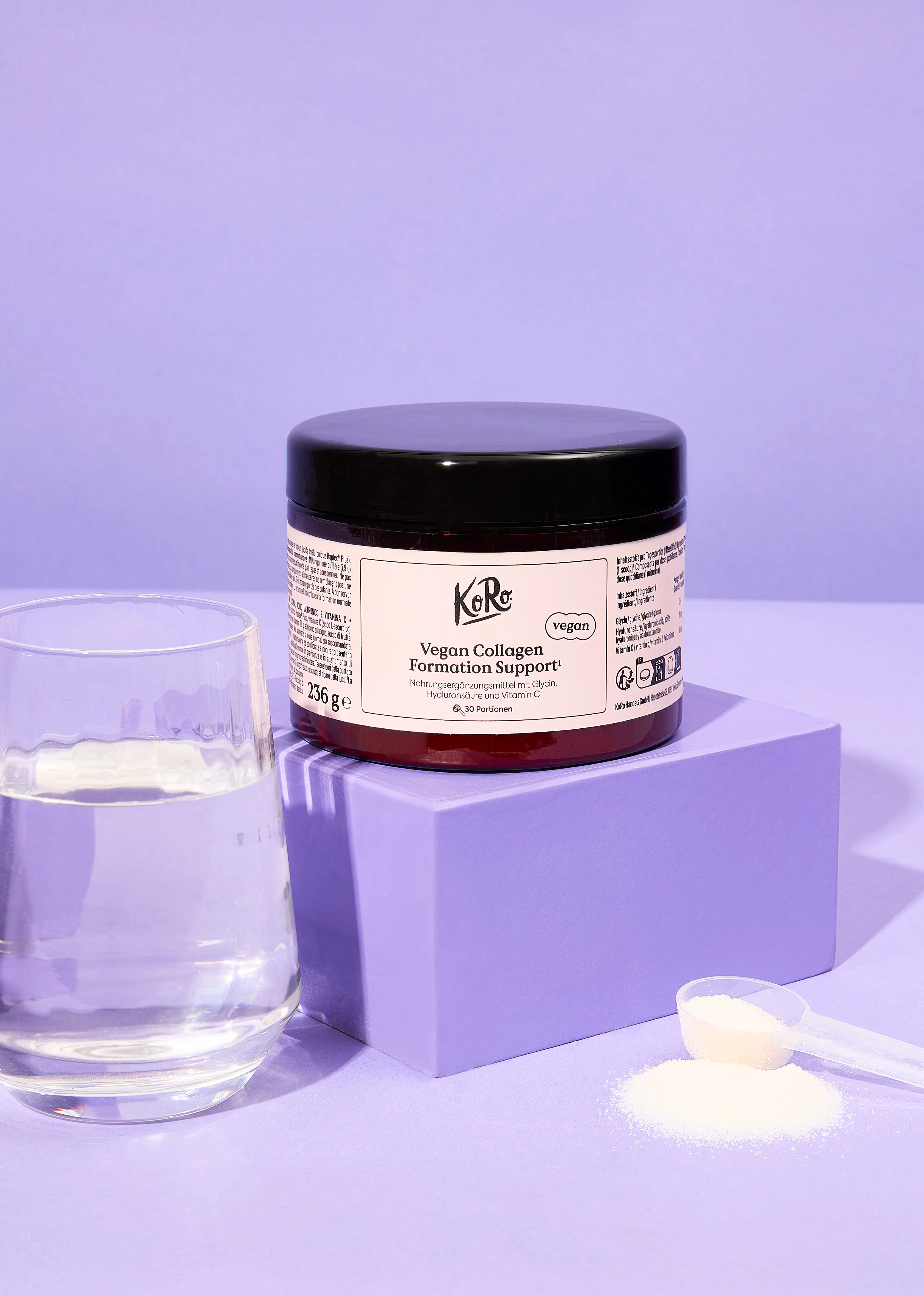 eine Dose veganes Kollagen-Formationssupport neben einem Glas Wasser