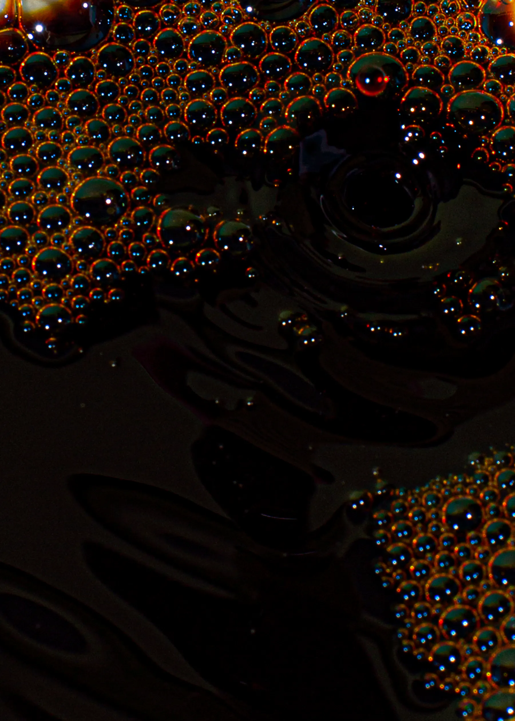 a close up of a dark liquid with bubbles in it