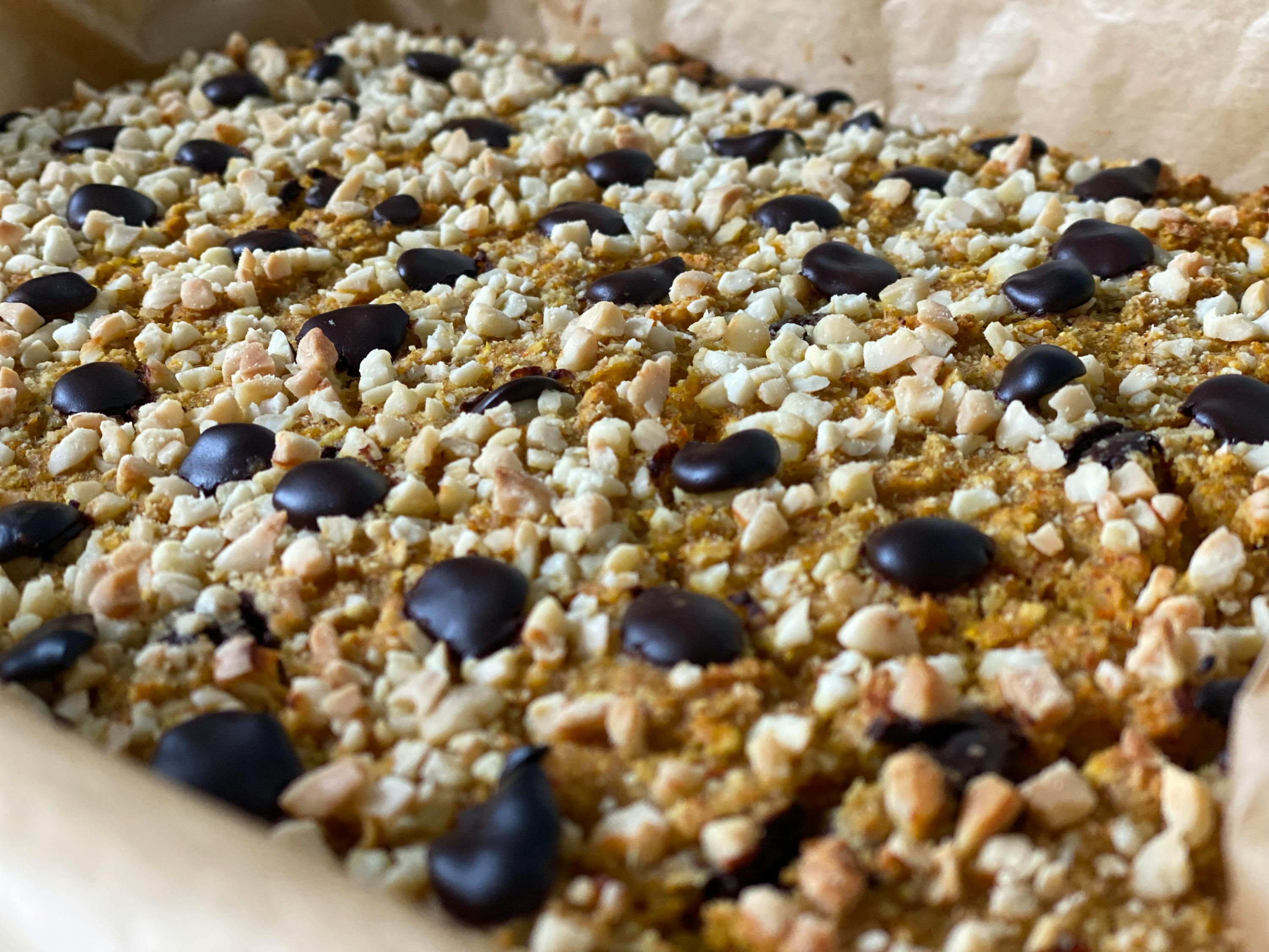 a close up of a dessert with chocolate chips and nuts