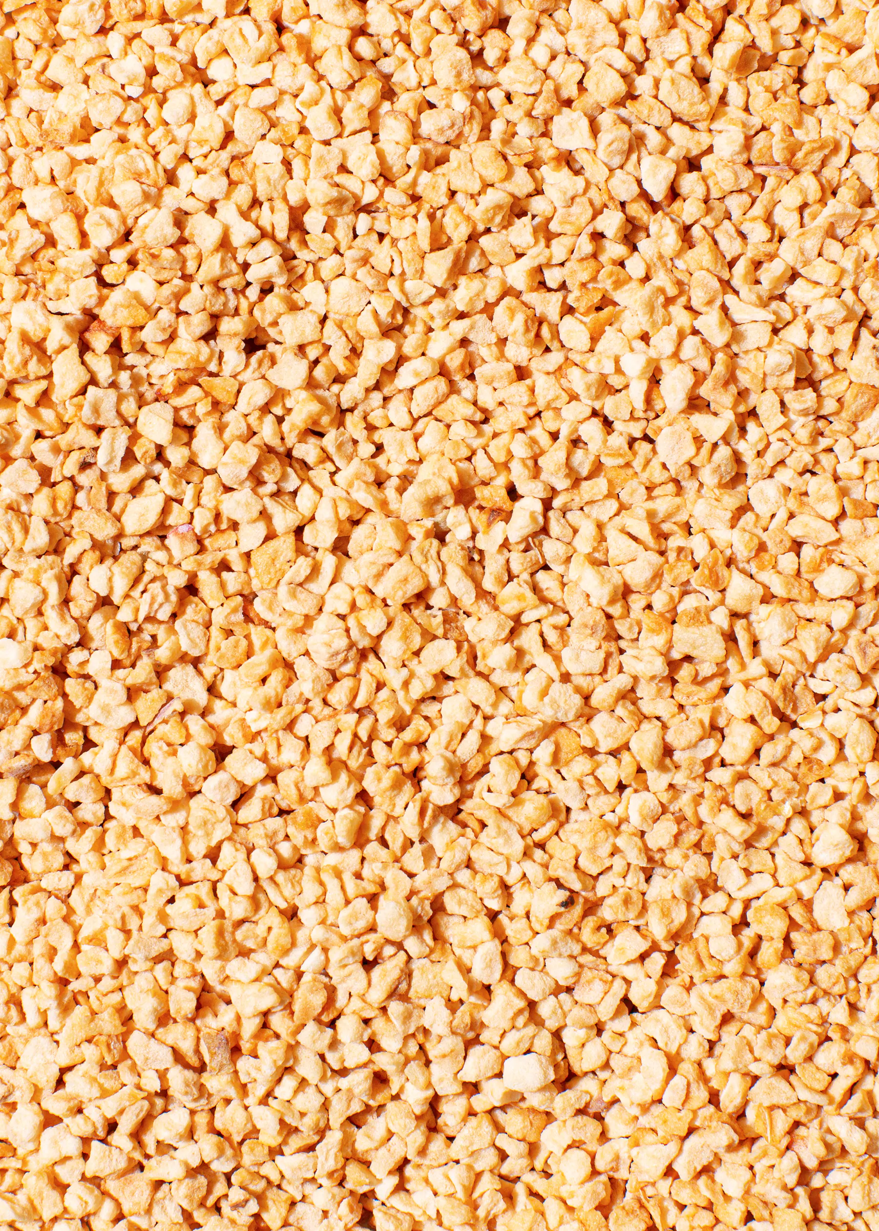 a close up of a pile of small yellow stones