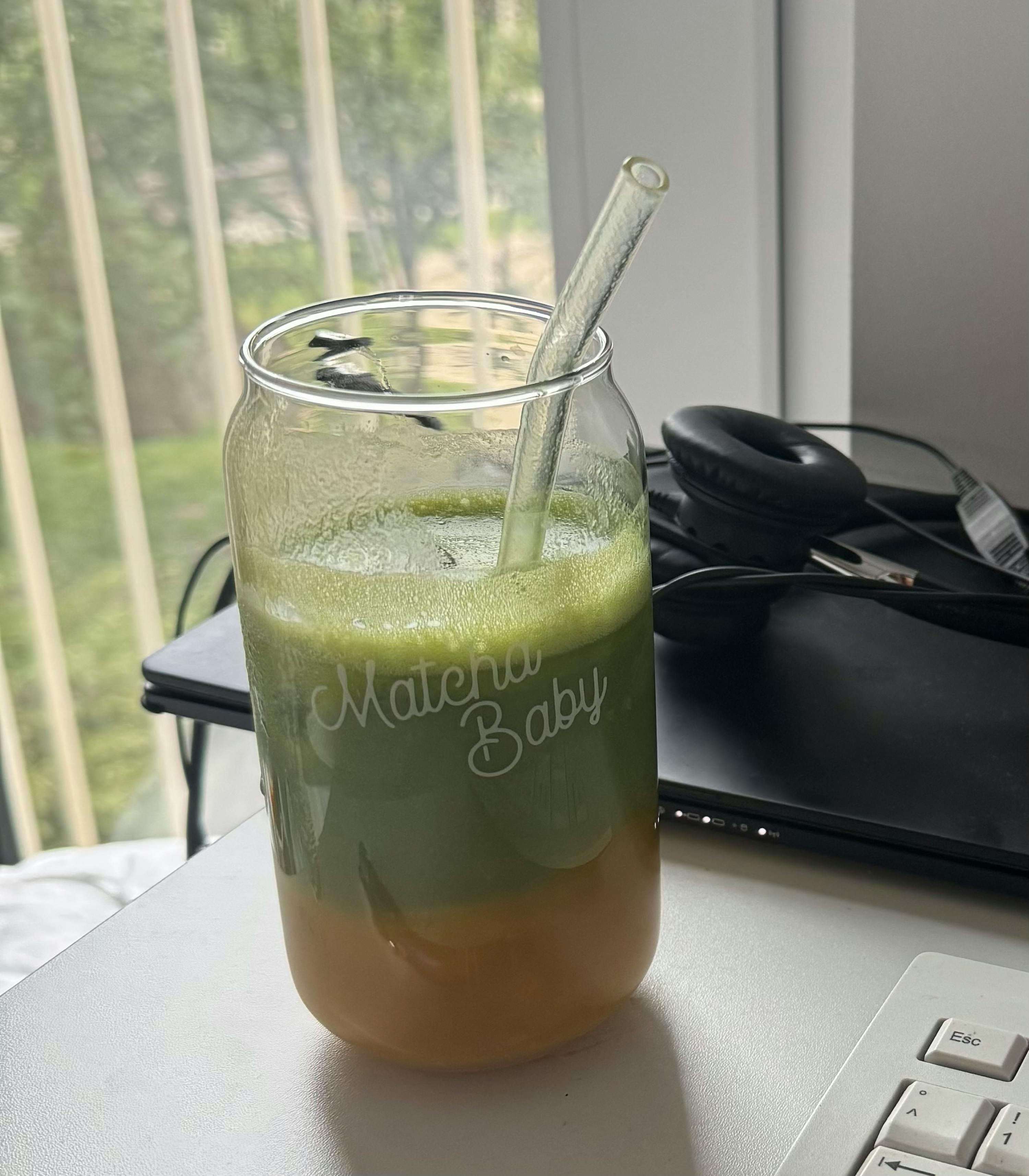 a green drink in a glass that says materia baby