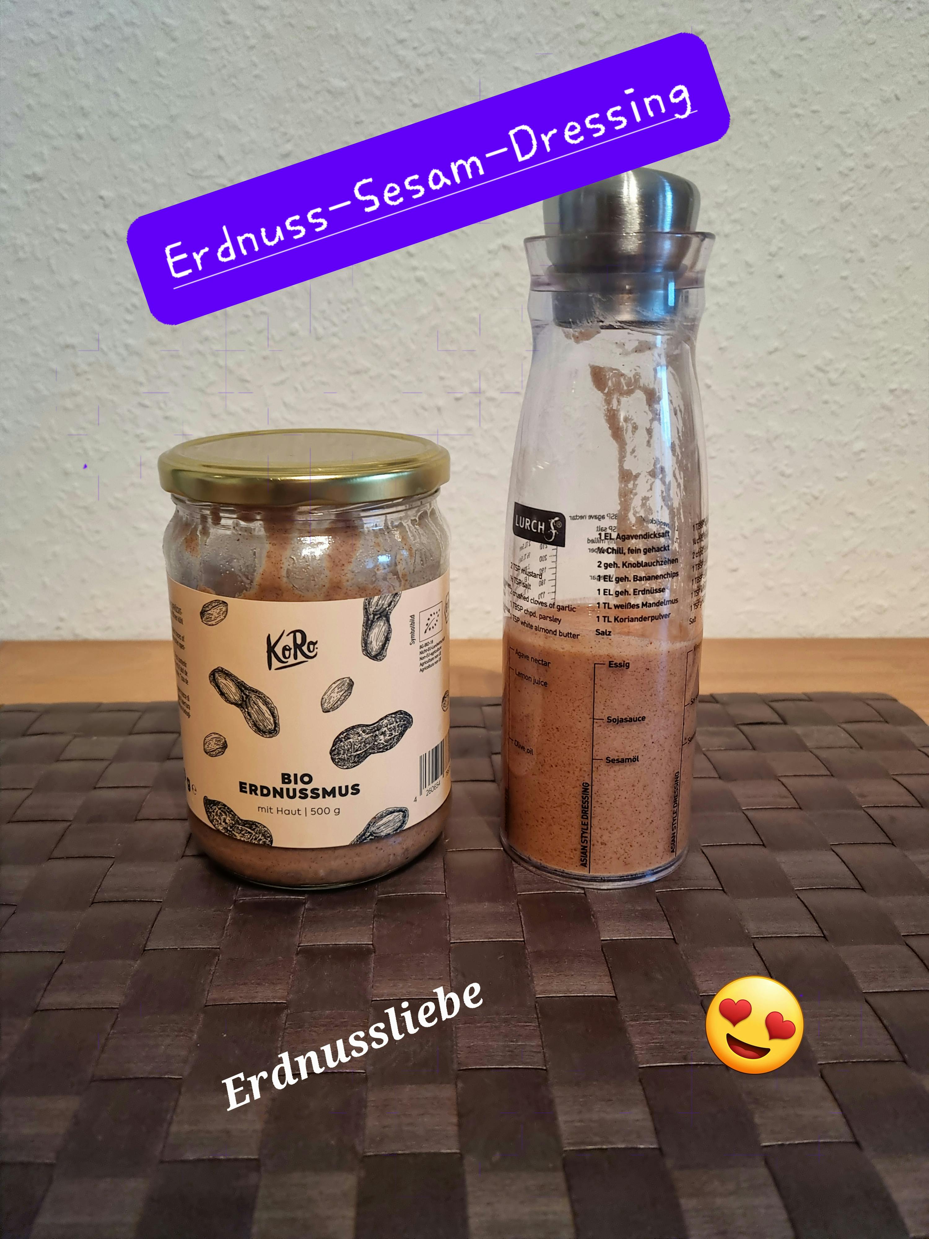 un bocal d' erdnuss-sesam-dressing est assis à côté d' une bouteille de mélangeur