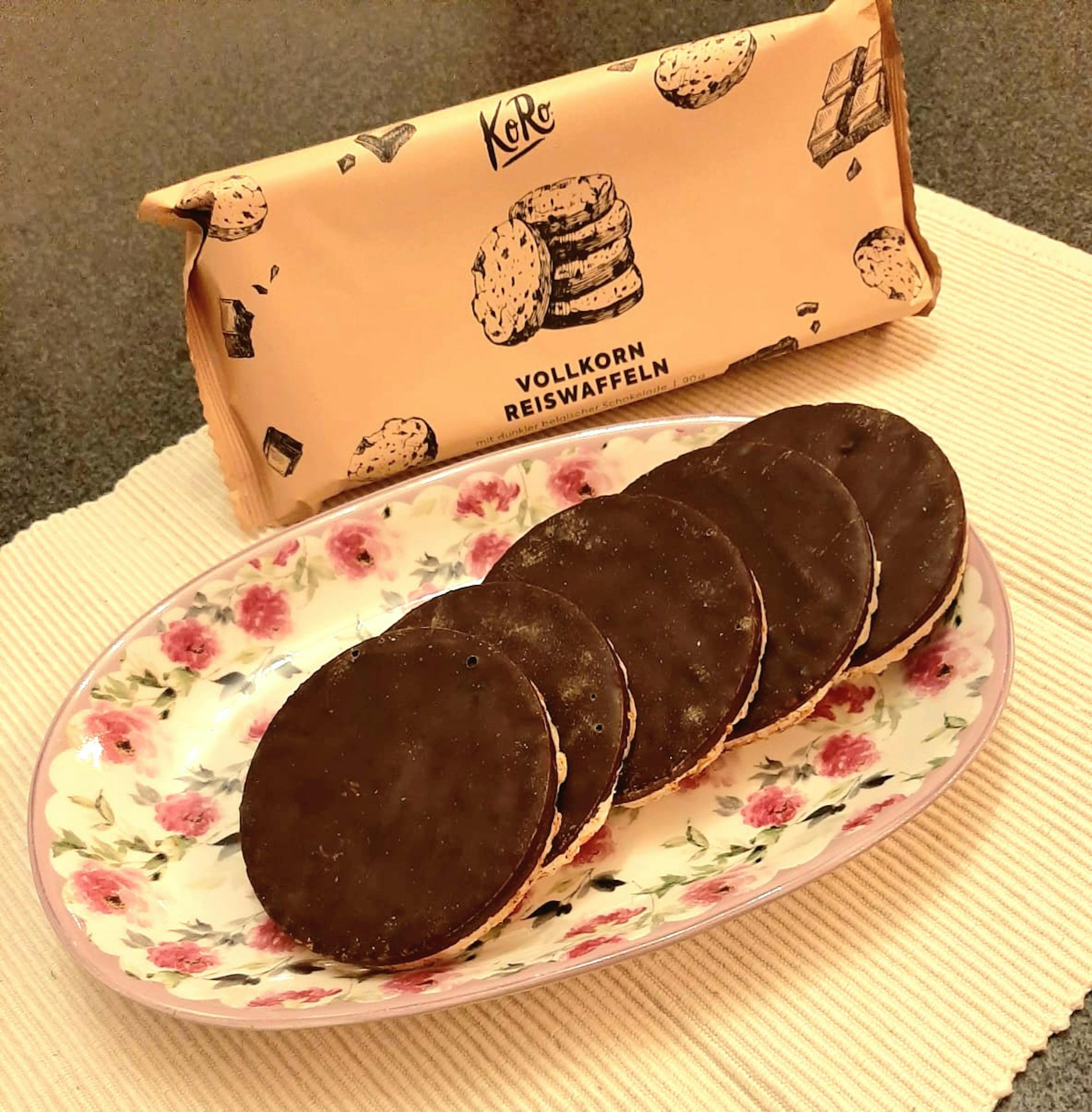 a package of vollkorn reiswaffeln cookies sits next to a plate of cookies