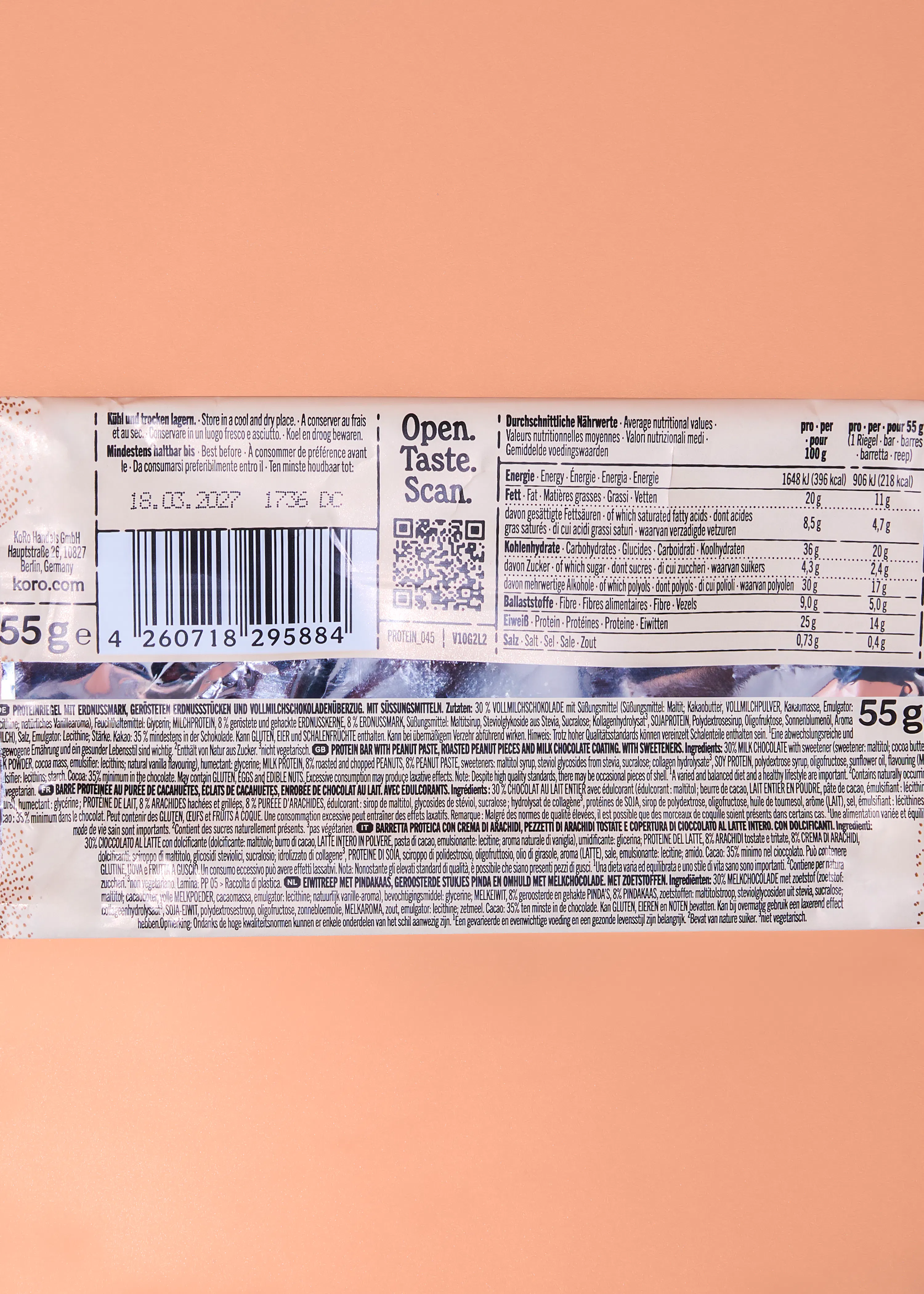 the back of a white koro protein bar wrapper with nutritional information, ingredients, a barcode, and a best before date.