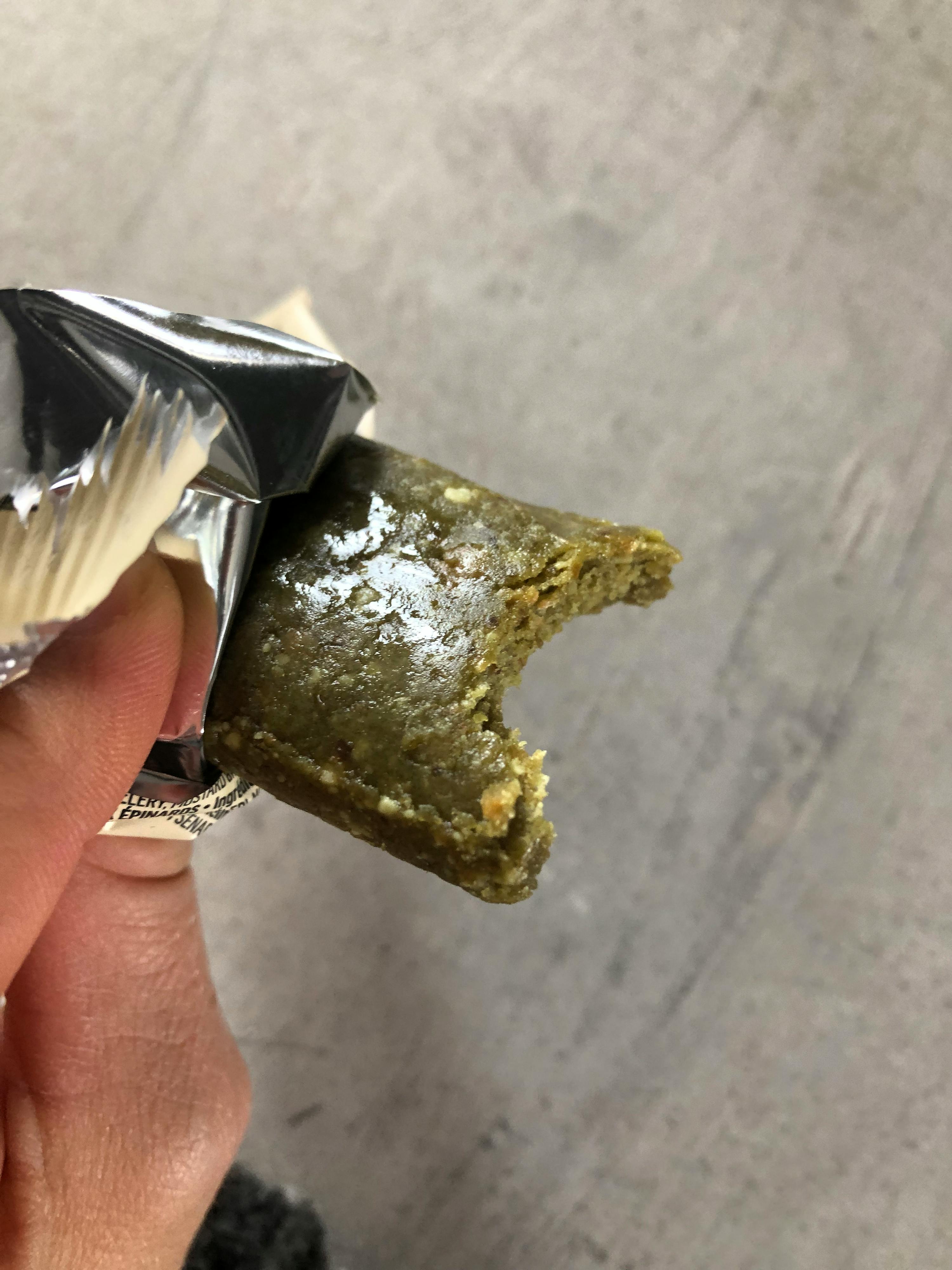 a person is holding a piece of food that has a bite taken out of it