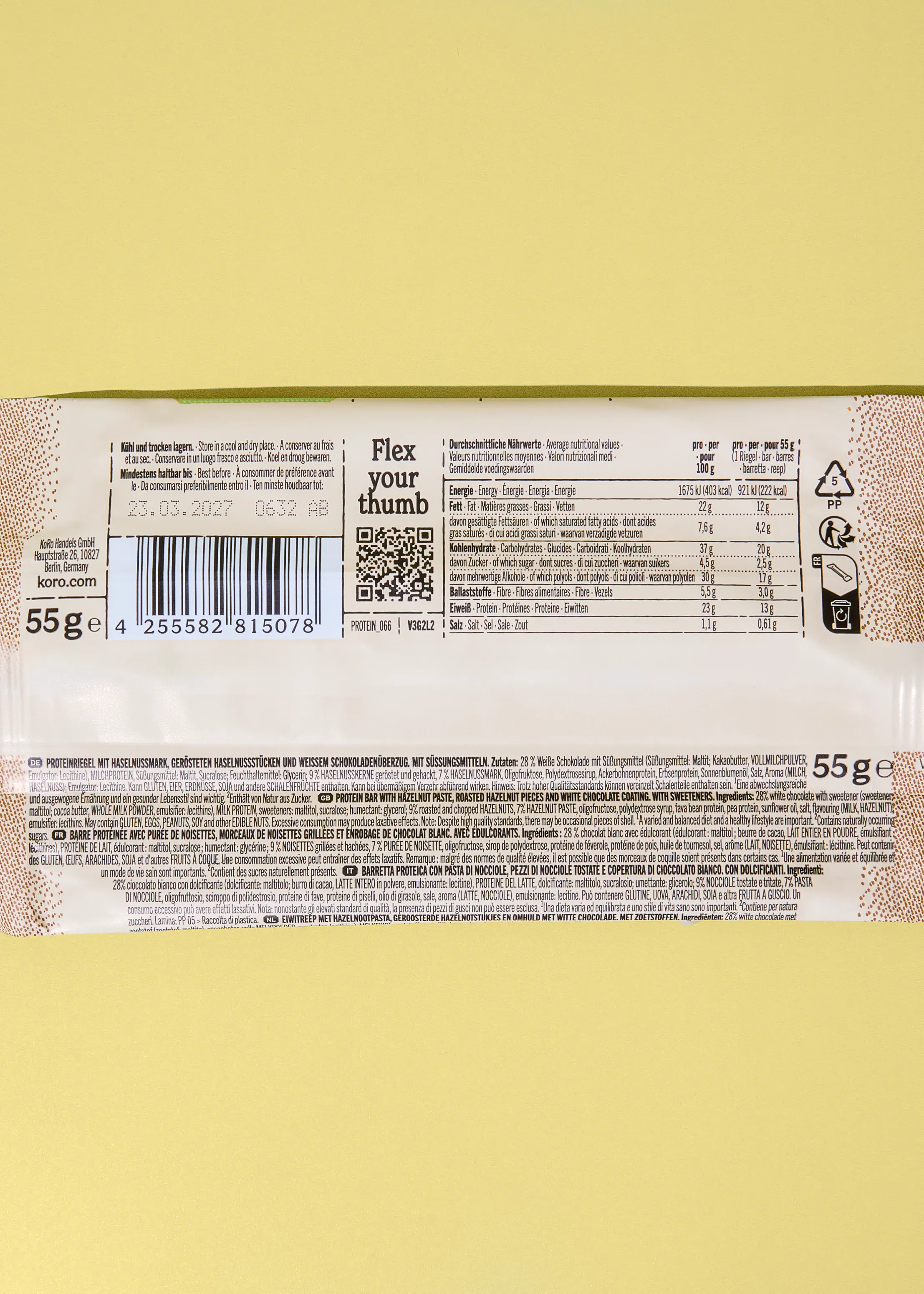 a protein bar wrapper displaying nutritional information, ingredients in multiple languages, a barcode, and a qr code.