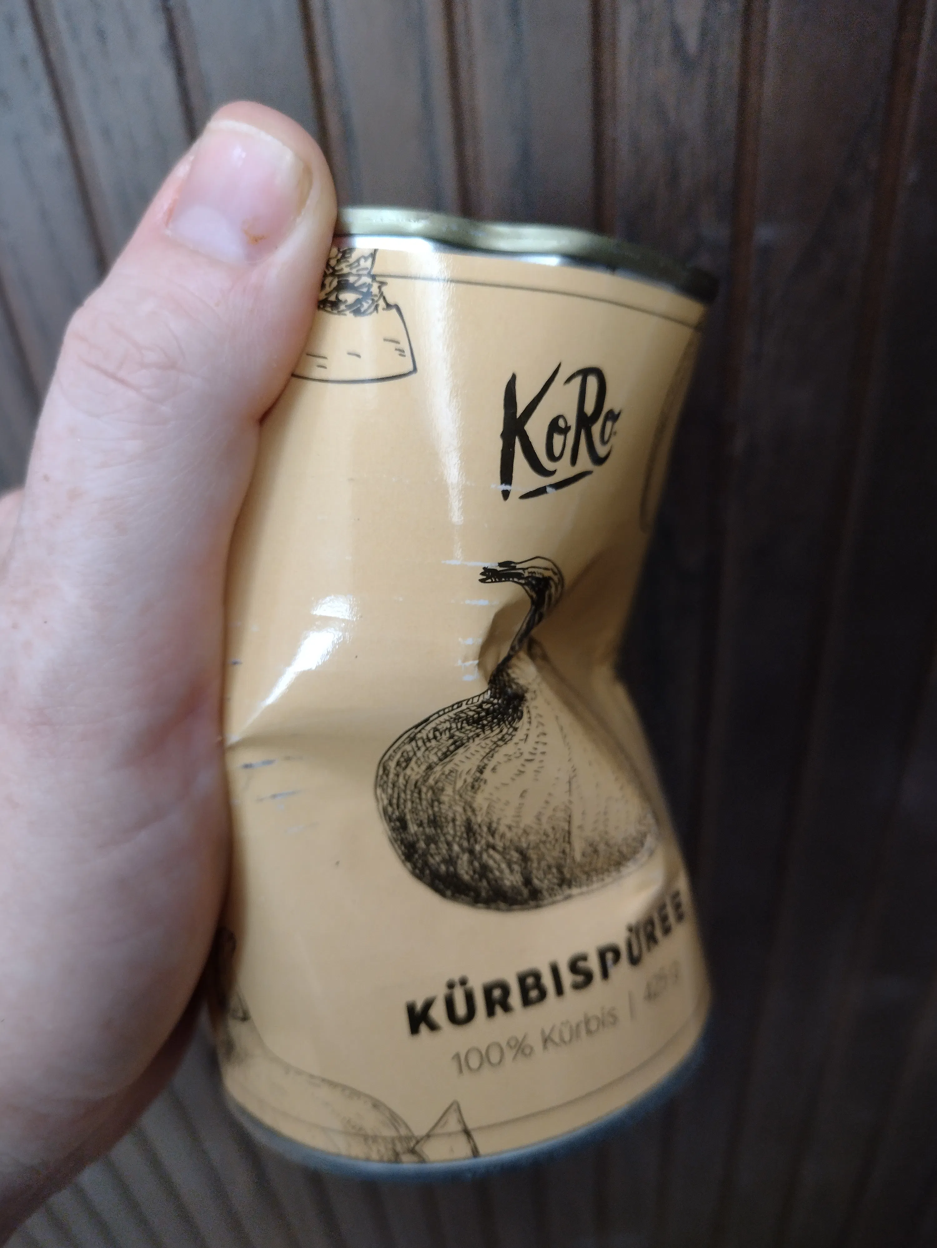 eine Person hält eine Dose Kürbispüree in ihrer Hand