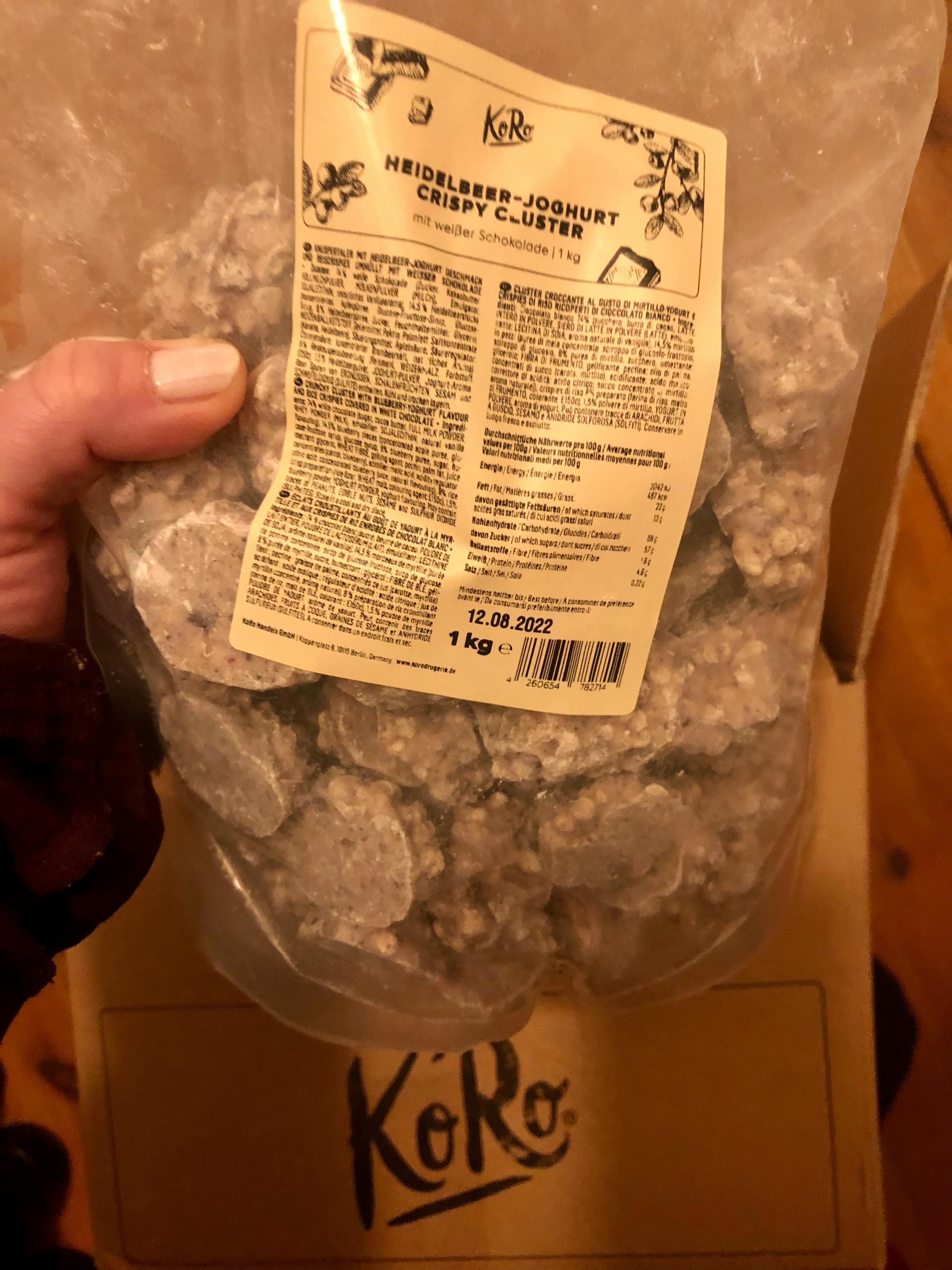 eine Person hält eine Tüte heidelber-joghurt-crispy-cluster in ihrer Hand