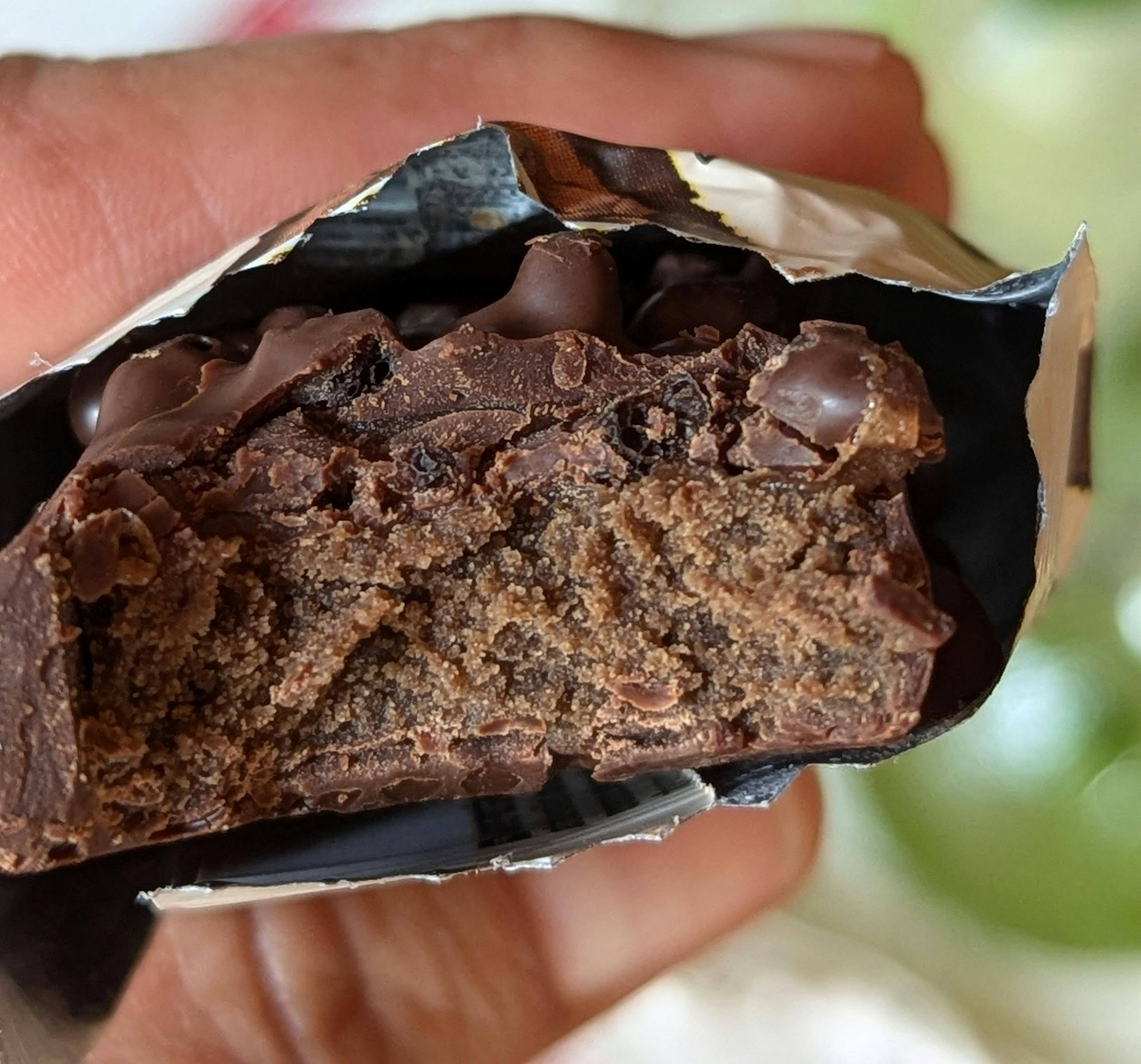 une personne tient une barre de chocolat dans sa main