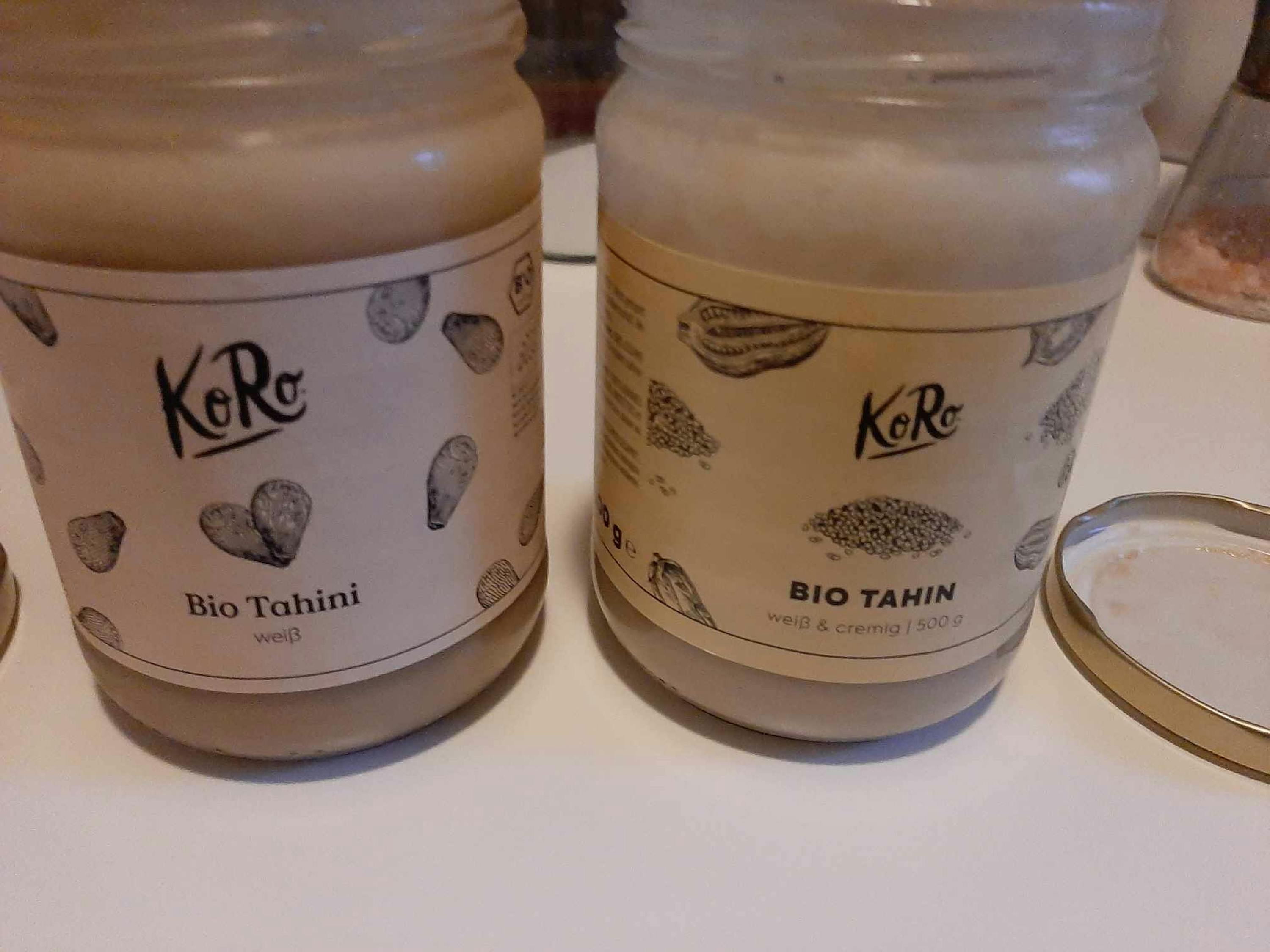 two jars of bio tahini sit on a table