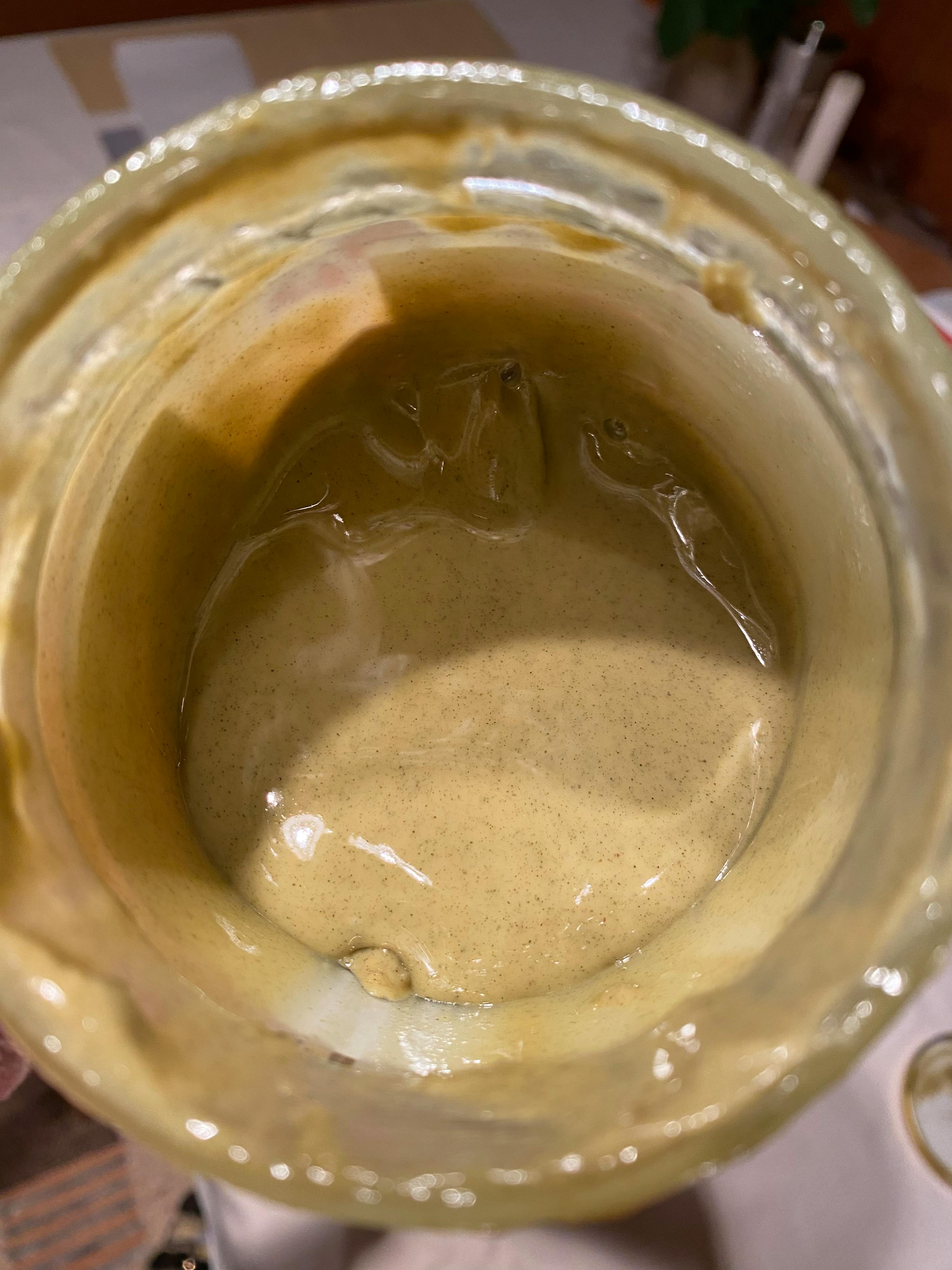 a close up of a jar with a yellow liquid in it