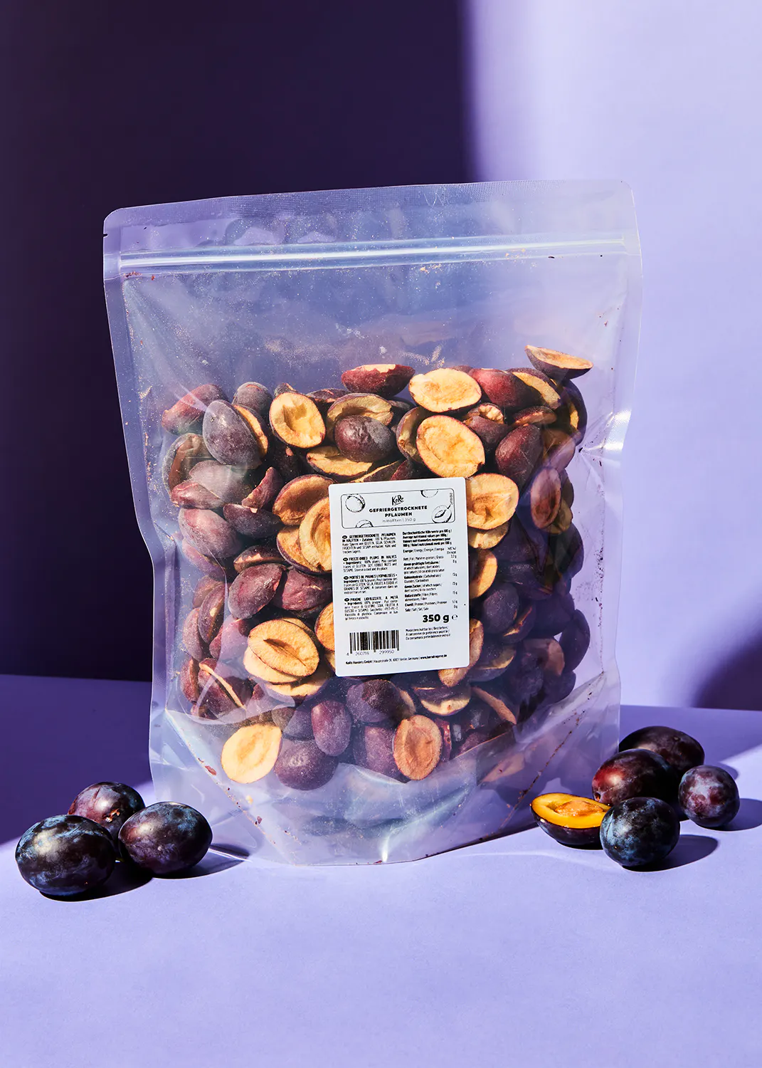 a bag of dried plums is sitting on a purple table